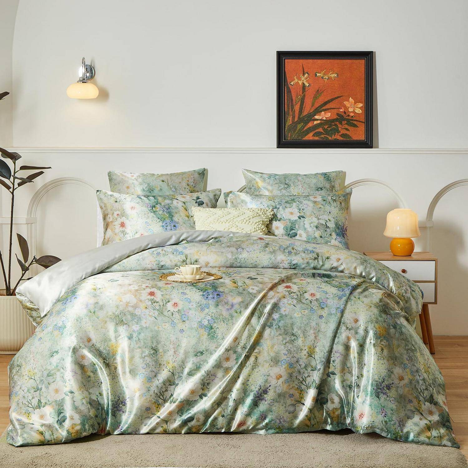 Blumenmuster-Bettwäsche auf einem ordentlich gemachten Bett in einem hellen Schlafzimmer, mit passenden Kissen, einer Nachttischlampe und einem gerahmten Kunstwerk über dem Kopfteil.