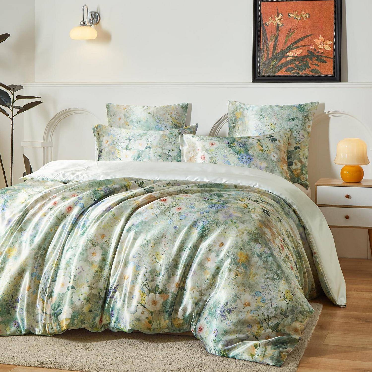 Blumenmusterbettwäsche-Set auf einem weißen Bett mit passenden Kissen in einem hellen, minimalistischen Schlafzimmer neben einem Nachttisch und einer Lampe.