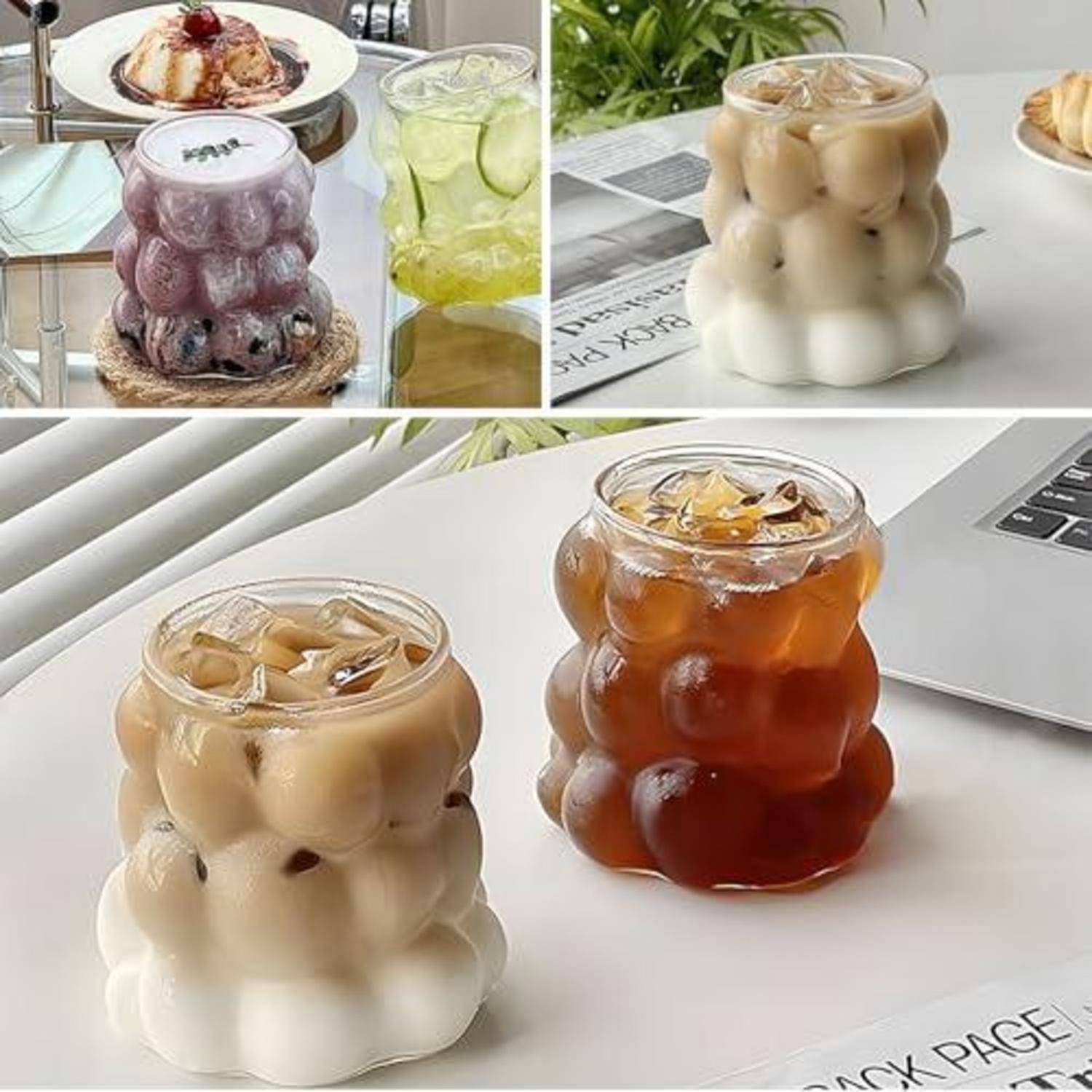 Drei blasenförmige Glastassen mit eisgekühlten Getränken in Beige- und Bernsteintönen, gezeigt auf einem weißen Tisch neben einem Laptop.