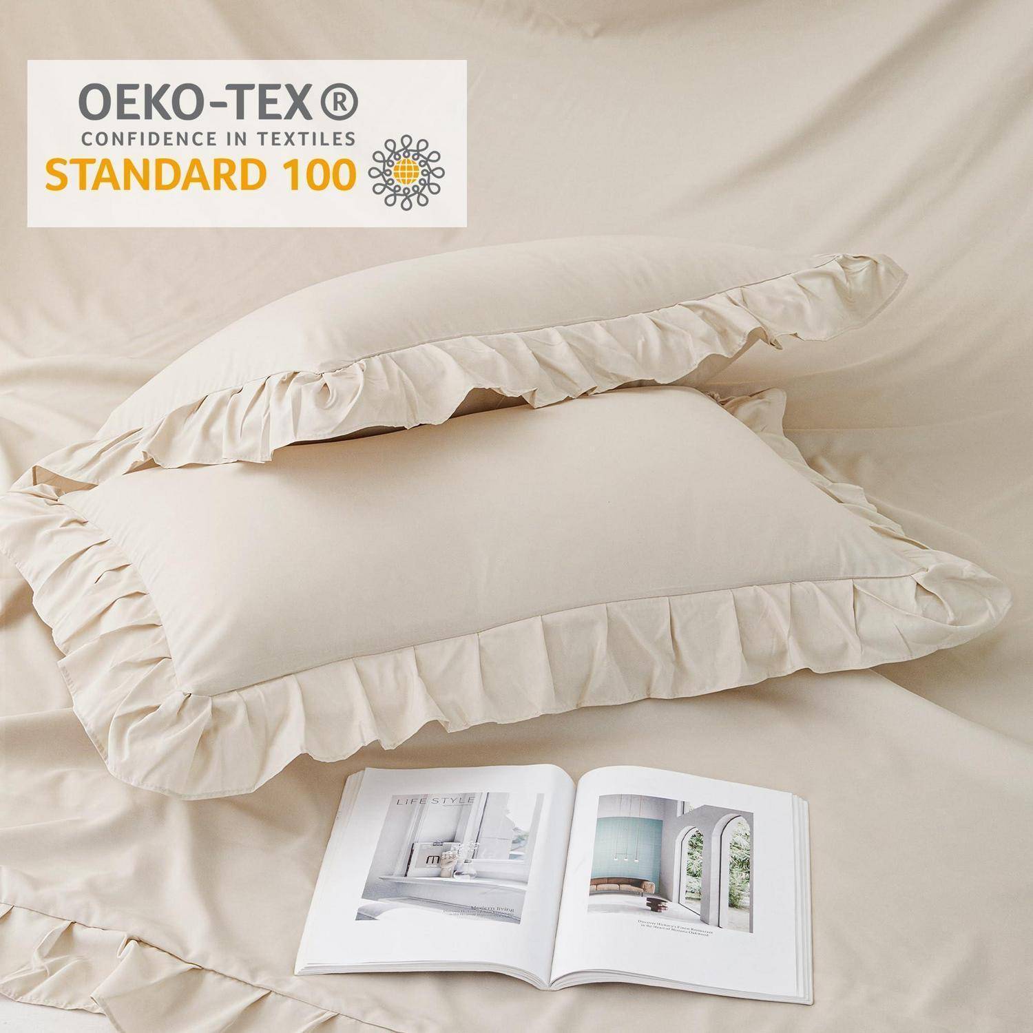 Beigekissen mit Rüschen auf Bettwäsche mit einer offenen Zeitschrift; OEKO-TEX Standard 100 Zertifizierungslogo oben links.
