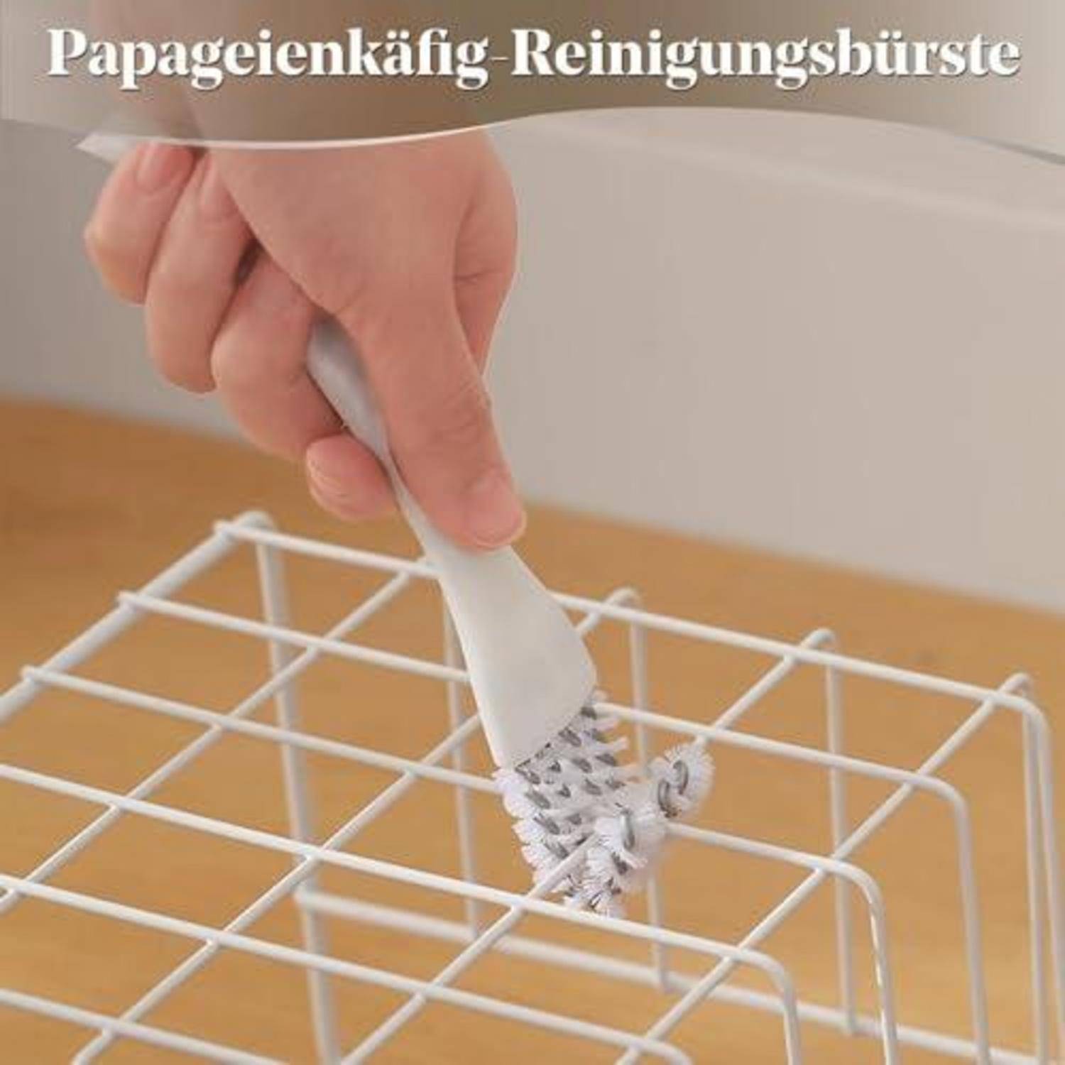 Handwerkzeug zum Reinigen eines weißen Vogelkäfiggitters mit einer weißen Bürste; der Text lautet „Papageienkäfig-Reinigungsbürste