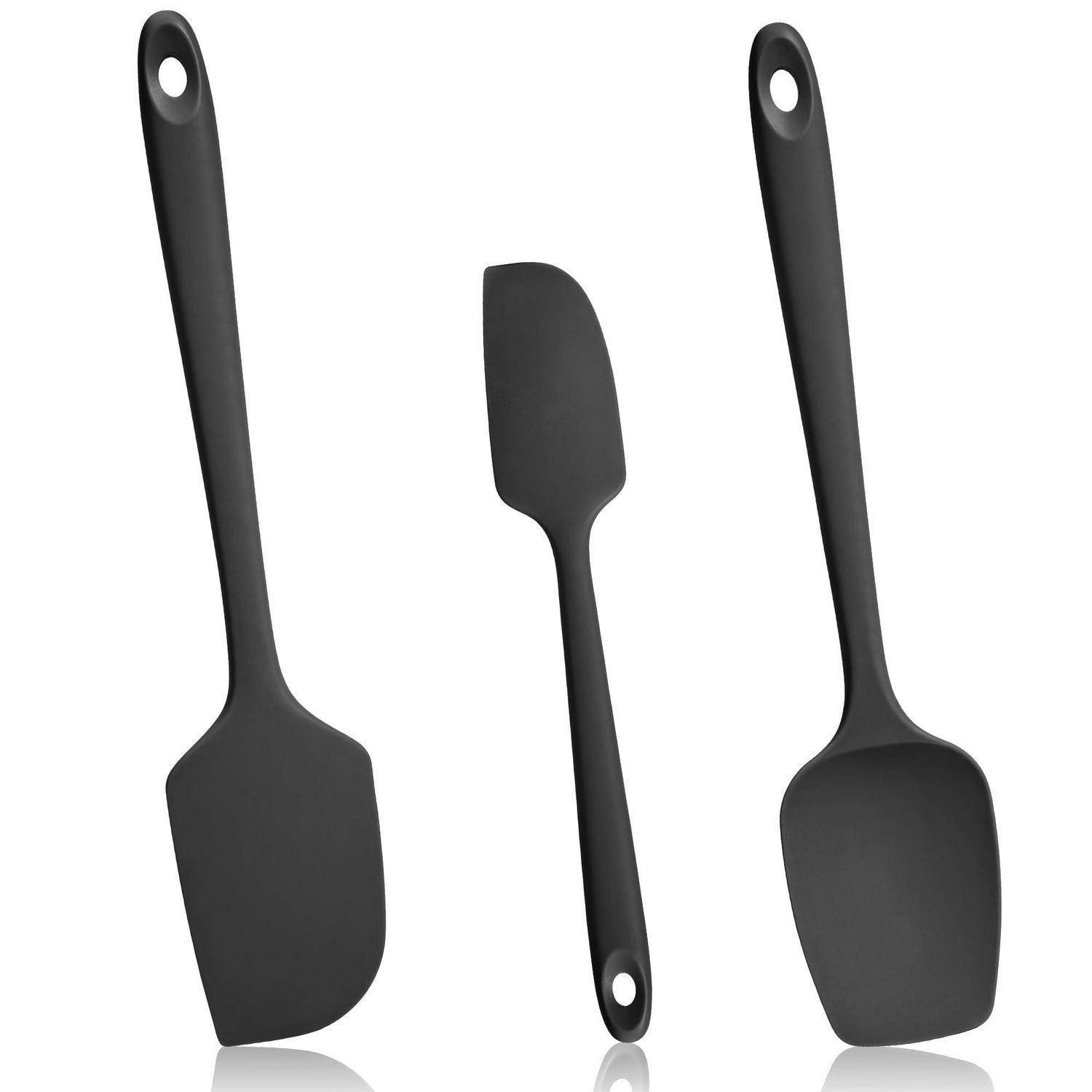 Drei schwarze Silikonspachtel auf weißem Hintergrund, bestehend aus zwei großen und einem kleinen, dargestellt als Küchenutensilien-Set.