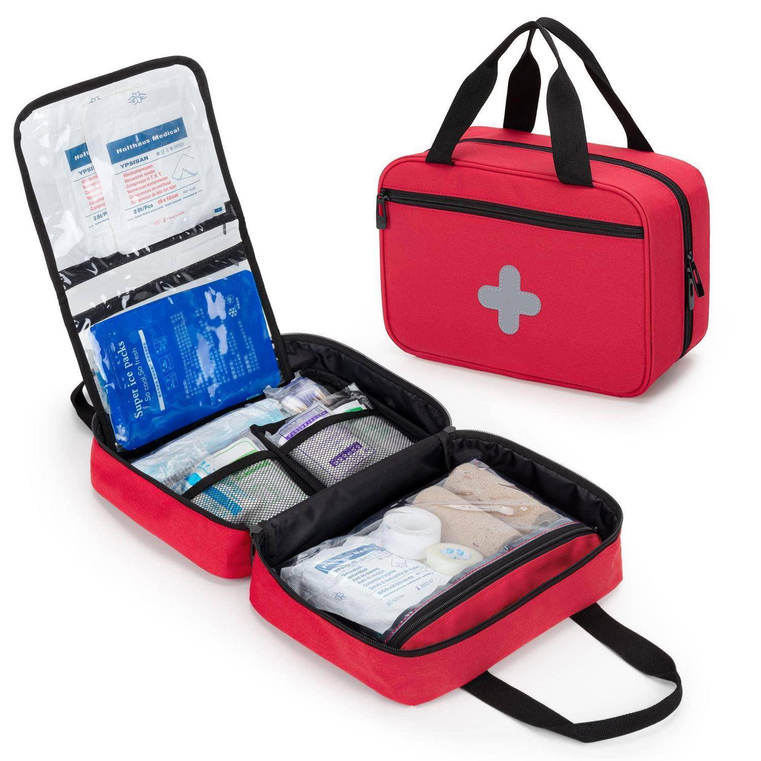 Offene rote Erste-Hilfe-Tasche mit Tragegriffen und weißem Kreuz, geöffnet, um organisierte Sanitäter und Kühlpacks zu zeigen.