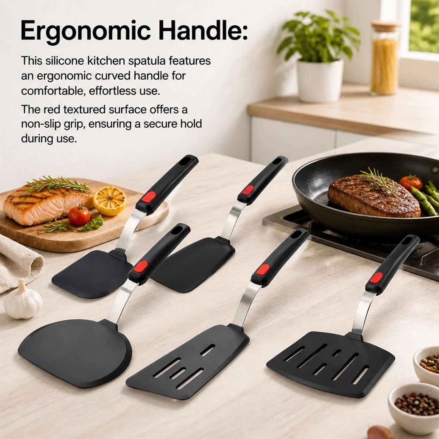 Produktbild von schwarzen Silikon-Küchenspachteln mit roten strukturierten ergonomischen Griffen, gezeigt auf einer Küchentheke neben gekochtem Essen und einer Pfanne.