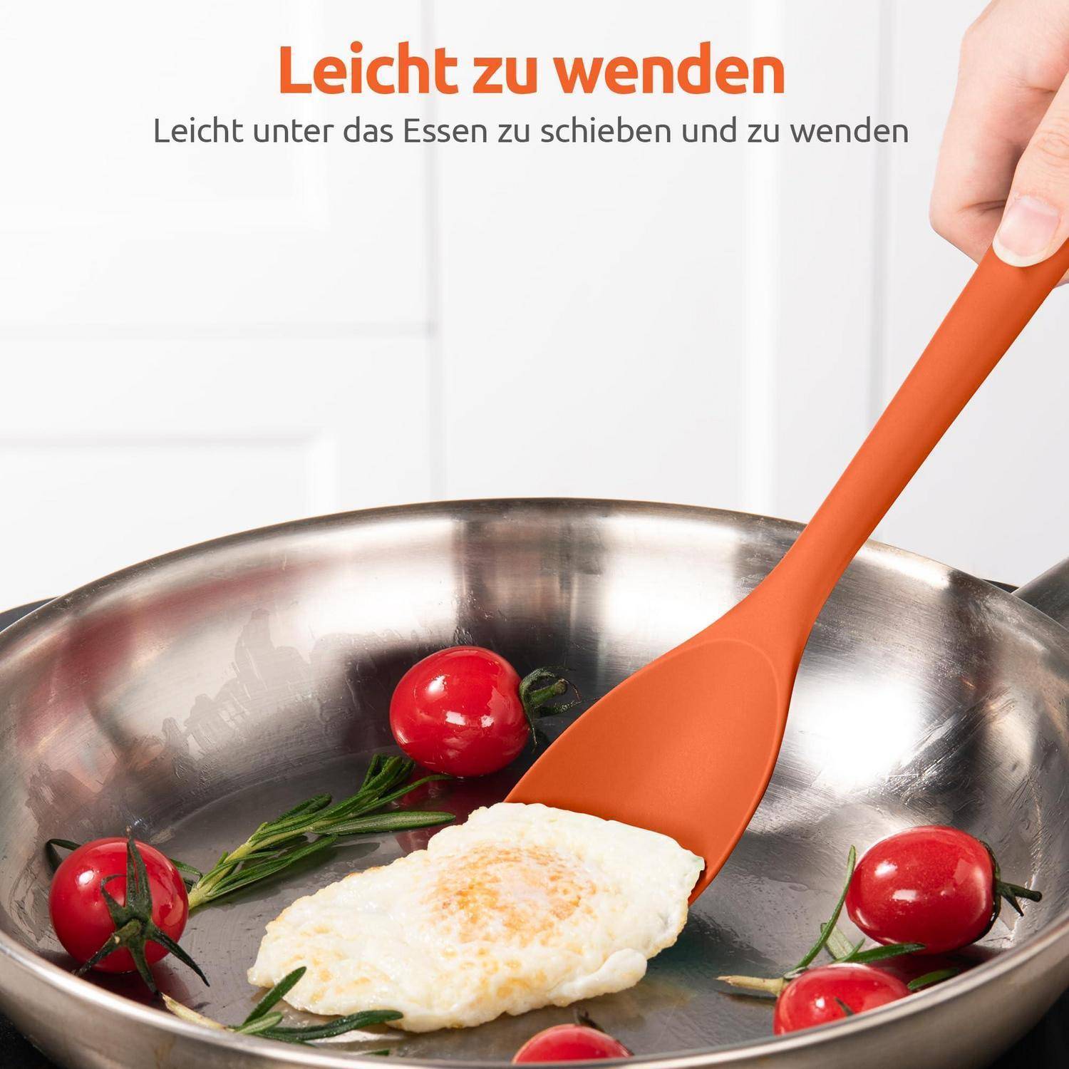 Eine orangefarbene Spatel hebt ein Spiegelei in einer Edelstahlpfanne mit Kirschtomaten und Kräutern; der Text sagt „Leicht umzudrehen