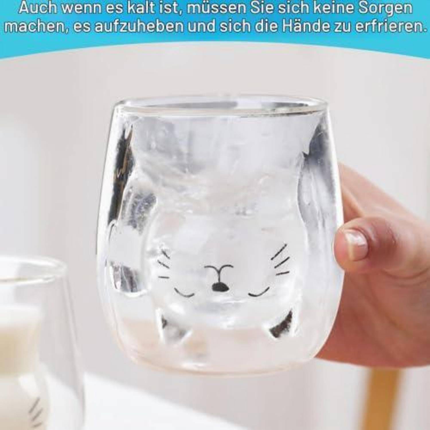 Eine Hand hält ein klares Glas mit einem niedlichen Katzenggesicht; das Getränk sieht gefroren aus und passt zum deutschen Text über kalte Getränke und dass Hände nicht einfrieren.