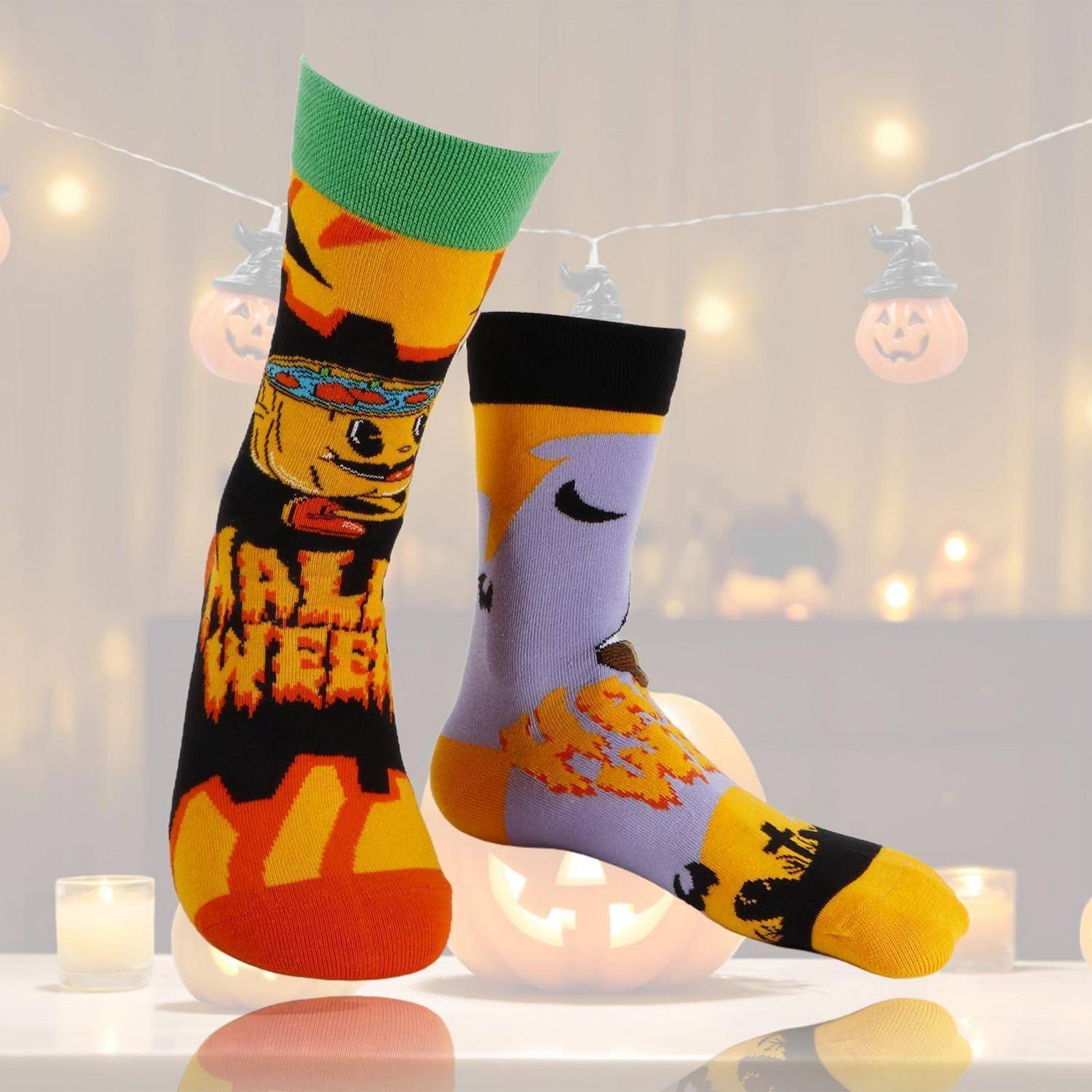 Zwei Halloween-Socken auf dem Display, eine schwarze mit einem Kürbisdesign und „HALLOWEEN"-Text, die andere lila und gelb mit einem Halbmond, angeordnet zwischen leuchtenden Jack-o'-Lantern-Lichtern.