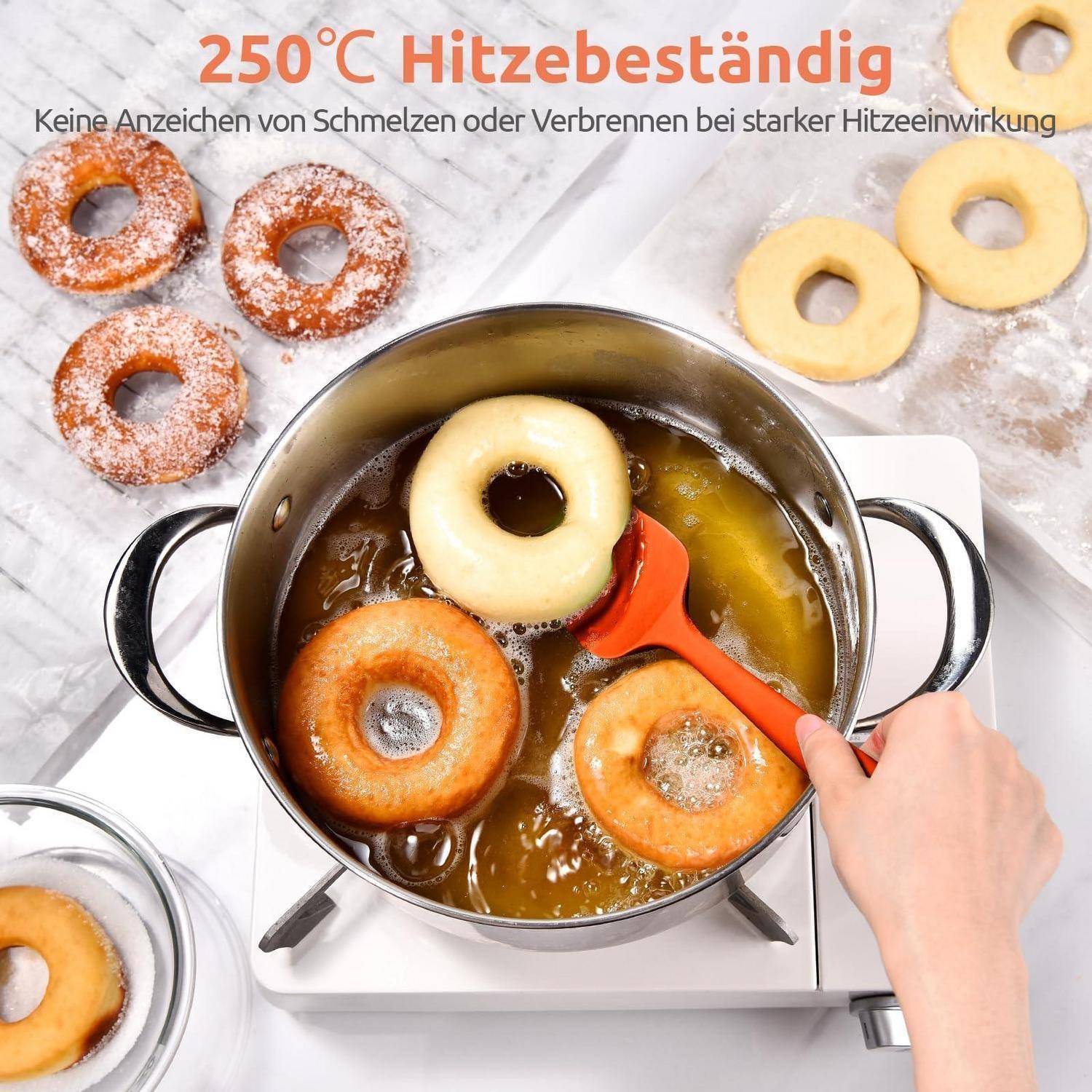 Topf mit frittierten Donuts auf einem Kochfeld, eine Hand rührt mit einem Spachtel um; Text besagt „250°C hitzebeständig