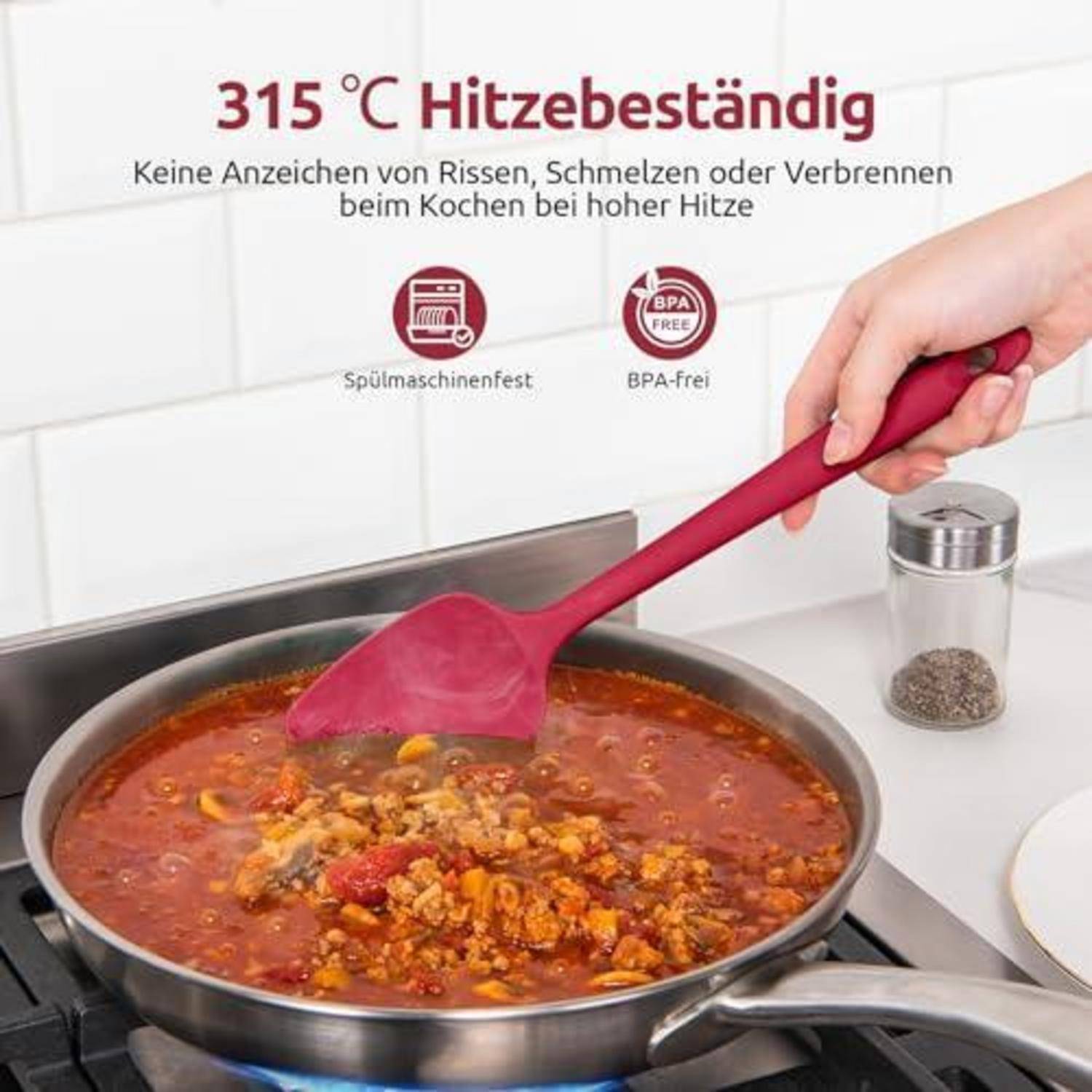 Hand hält einen roten Silikonspatel, der köchelnde Fleischsoße in einer Pfanne umrührt; Text besagt „bis 315°C hitzebeständig