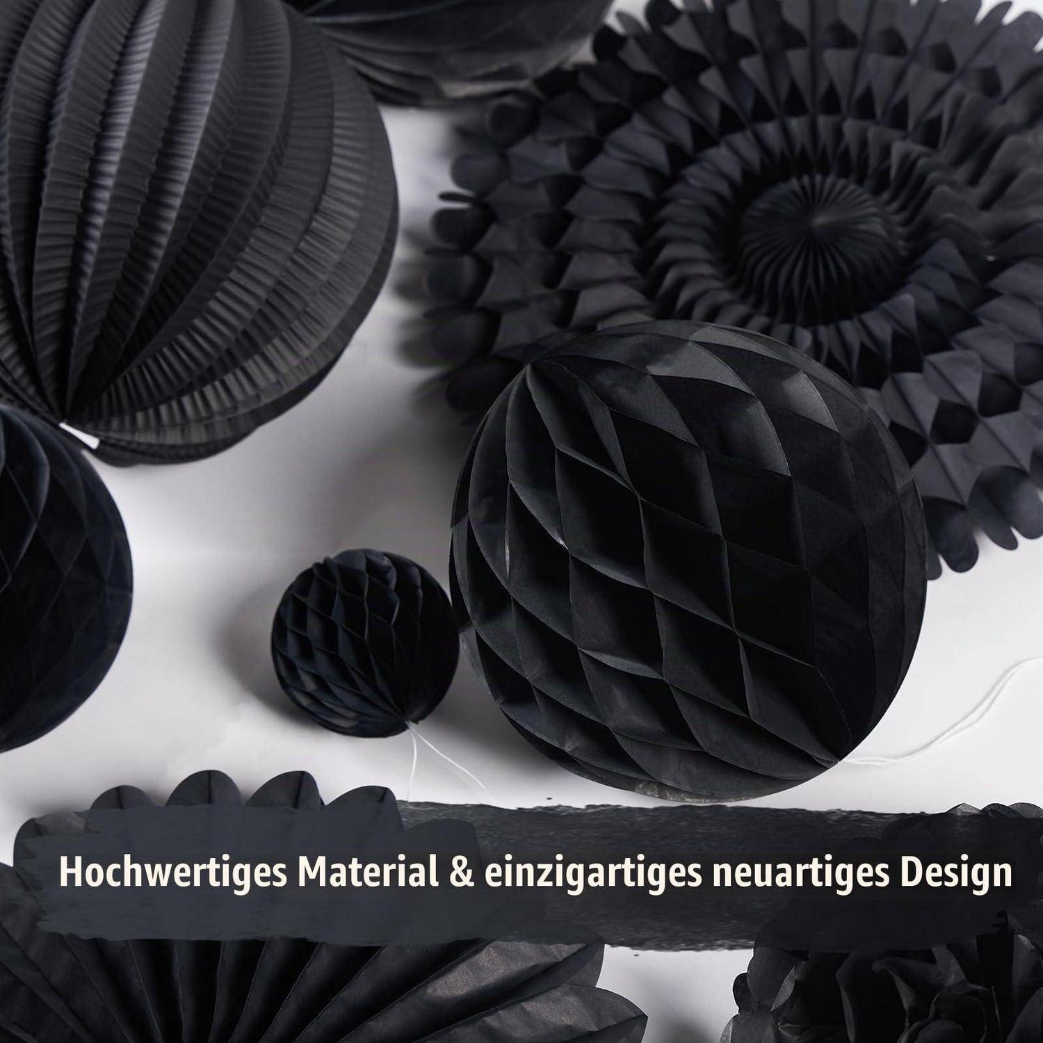 Sortierte schwarze gefaltete Papierdekoration mit Text "Hochwertiges Material & einzigartiges neuartiges Design"" über dem unteren Rand.