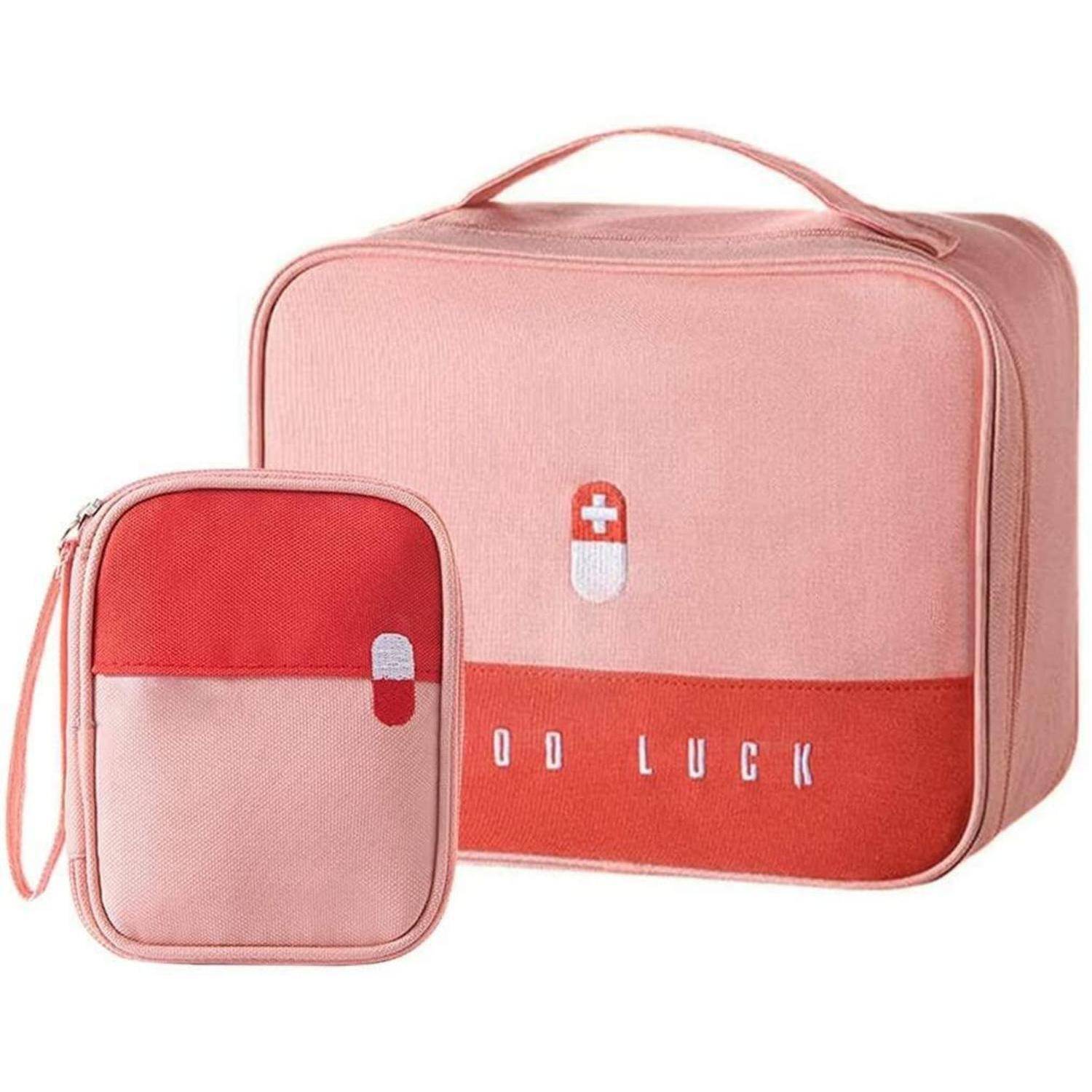 Rosa Lunchbox und passendes kleines Täschchen mit roten Akzenten und Pillensymbol, beschriftet mit „VIEL GLÜCK