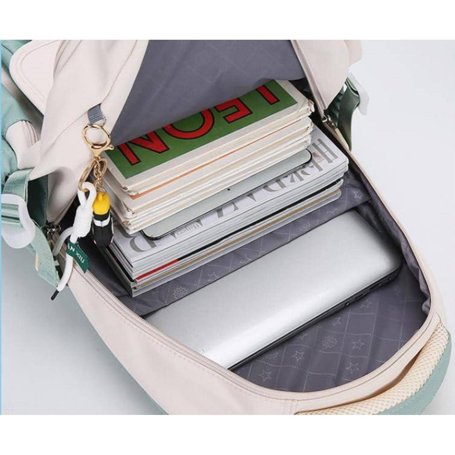 Offener Rucksack mit gestapelten Notizbüchern/Büchern und einem Laptop im Inneren, der organisierte Schul- oder Arbeitsspeicherung hervorhebt.