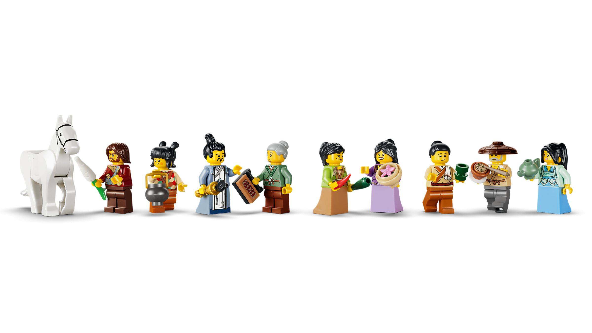 Eine Reihe von LEGO-Minifiguren in historischen Kostümen und ein weißes Pferd, die verschiedene Epochen oder Kulturen andeuten.