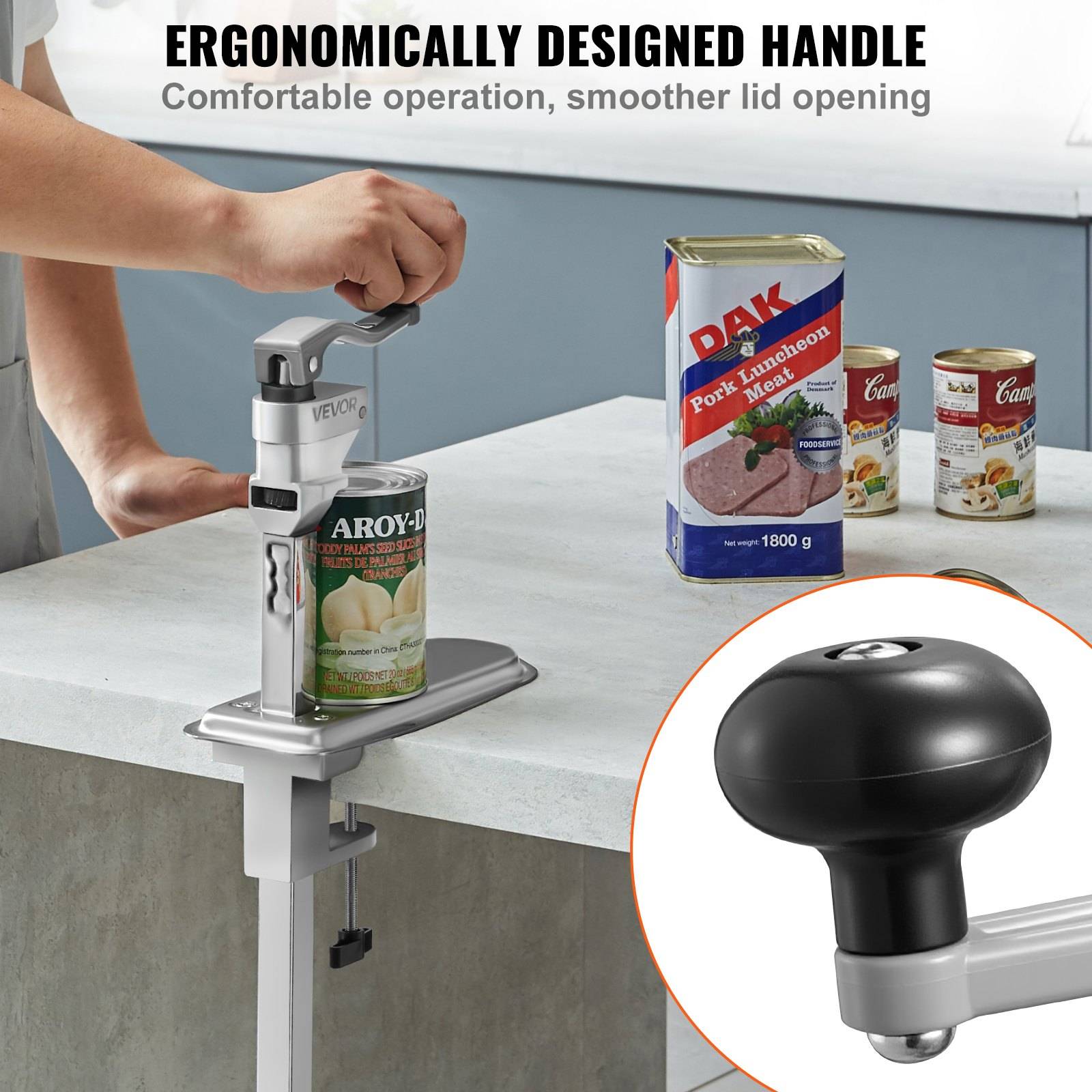 Tragbarer Dosenöffner, der an die Arbeitsplatte geklemmt ist, öffnet eine Dose; Die Einschub zeigt seinen ergonomischen Griff mit dem Text „Ergonomisch gestalteter Griff" und „Komfortabler Betrieb, sanfteres Öffnen des Deckels"".