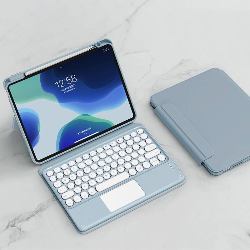 Tablet in einem blauen Keyboard-Case mit Trackpad und passendem Cover, geöffnet auf einer hellen Marmoroberfläche gezeigt.
