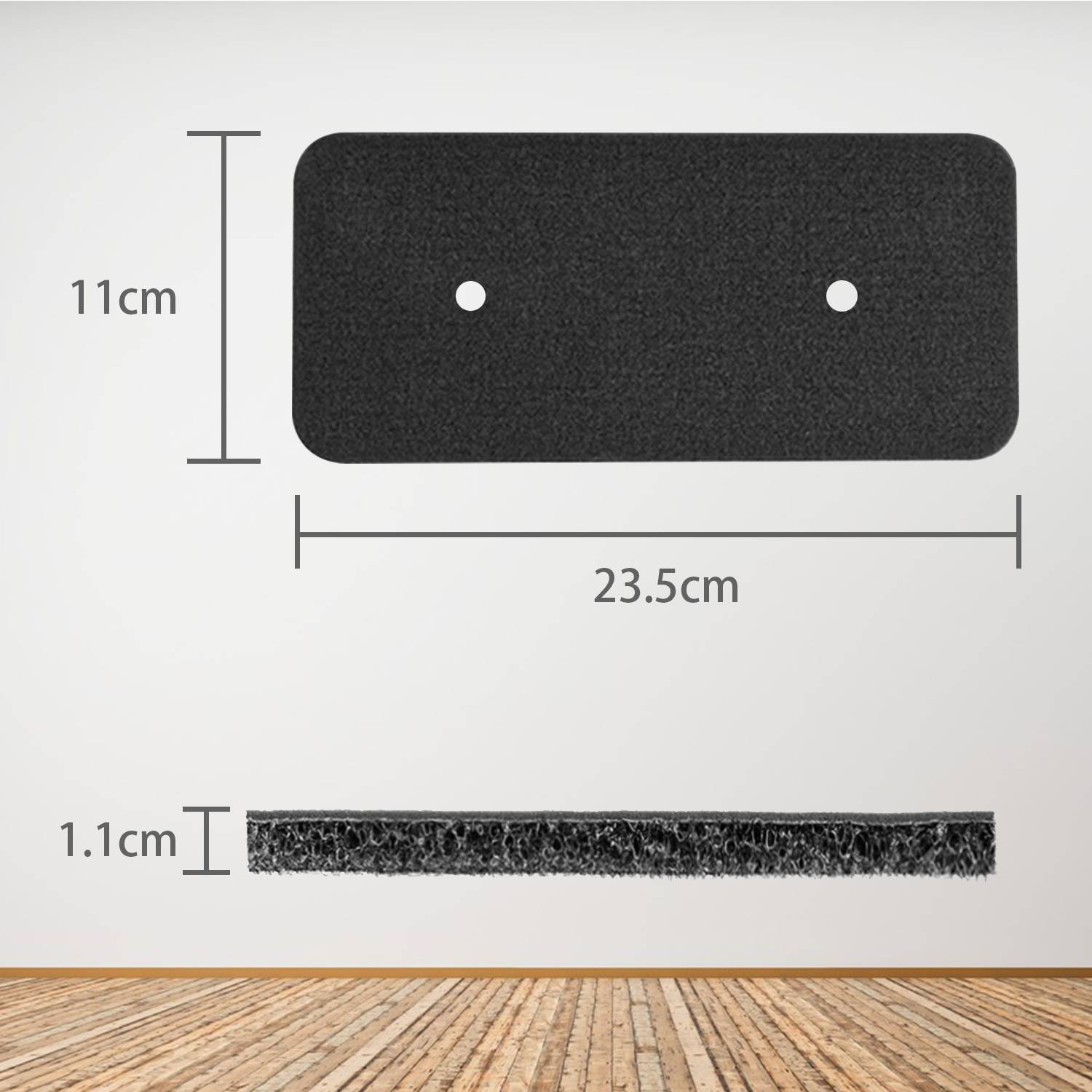 Schwarze rechteckige Matte mit abgerundeten Ecken, 23,5 cm breit, 11 cm hoch und 1,1 cm dick, dargestellt mit zwei mittigen Löchern und einer Seitenansicht.
