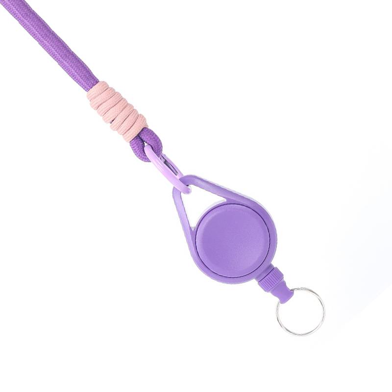 Violette einziehbare Schlüsselkordel mit rundem Ausweishalter und Metallschlüsselring auf weißem Hintergrund.