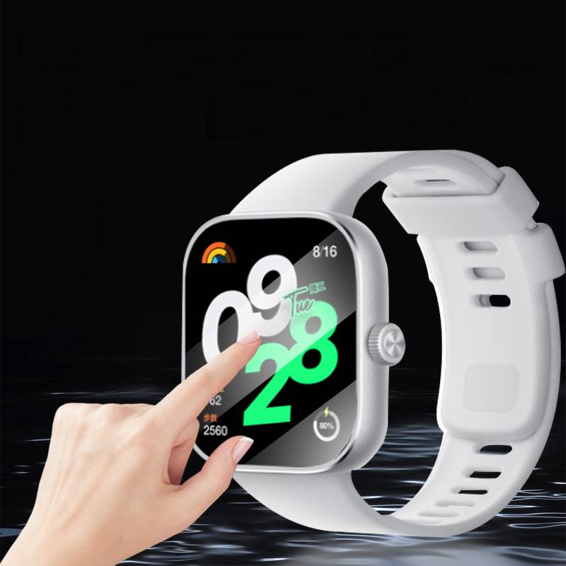 Hand, die eine weiße Smartwatch berührt, die auf schwarzem Hintergrund ein farbiges digitales Zeitanzeige-Display zeigt.