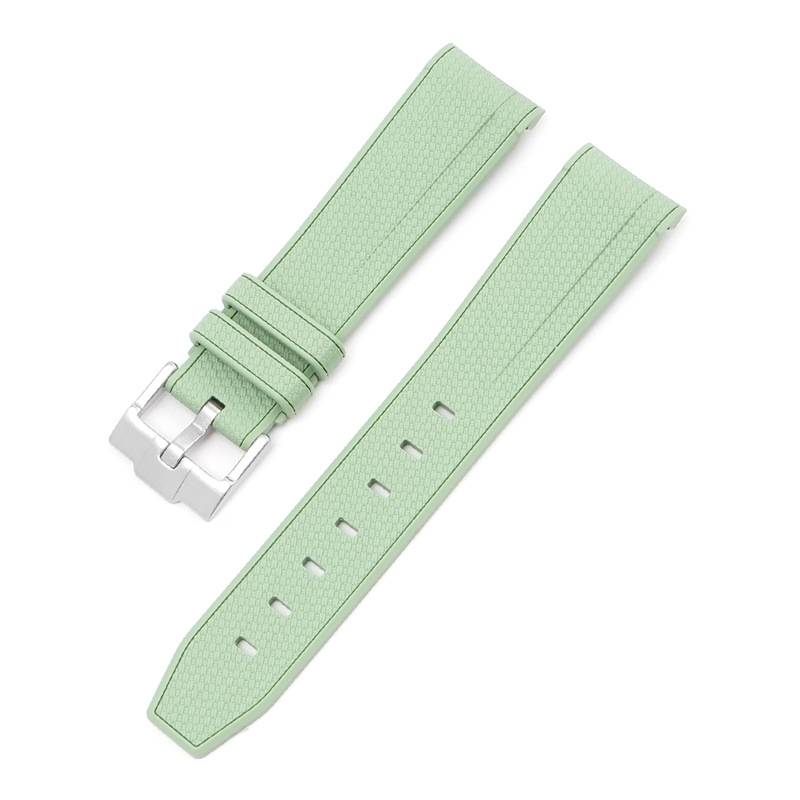 Helles mintgrünes strukturiertes Uhrenarmband mit silberner Schließe, in zwei Teilen auf weißem Hintergrund dargestellt.
