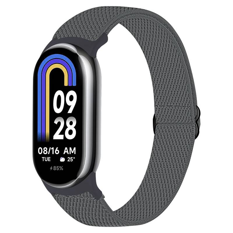 Graue Fitness-Smartwatch mit gewebtem Armband, zeigt ein schwarzes Display mit farbigem Bogen-Grafikdesign, Uhrzeit 09:28, Datum 08/16 Di, 25°, und 85% Akkuladung.