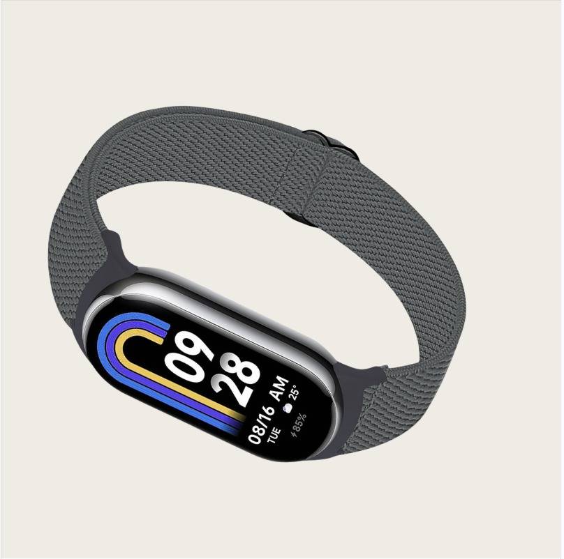 Ein graues Fitness-Armband mit einem Farbdisplay, das 09:28 Uhr, Dienstag 16.08 und eine Herzfrequenz von 85 BPM anzeigt.