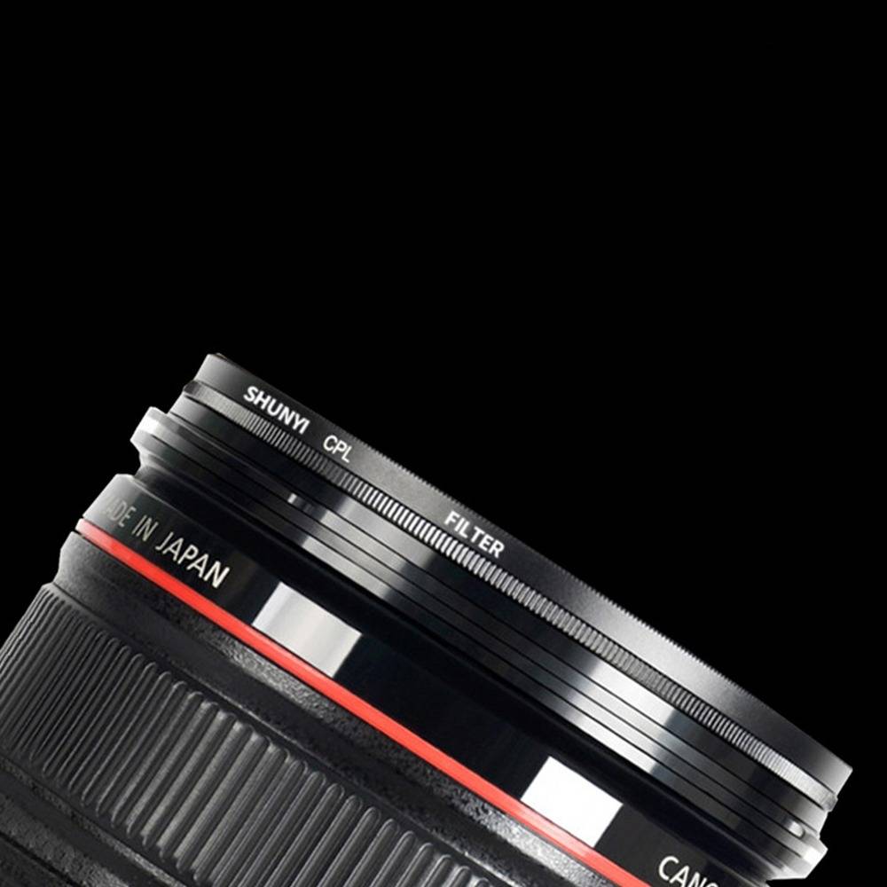 Nahaufnahme eines SHUNYI CPL Kameraobjektiv-Filters, schräg auf schwarzem Hintergrund angebracht, zeigt den gerippten Metallring und den Text "MADE IN JAPAN"".