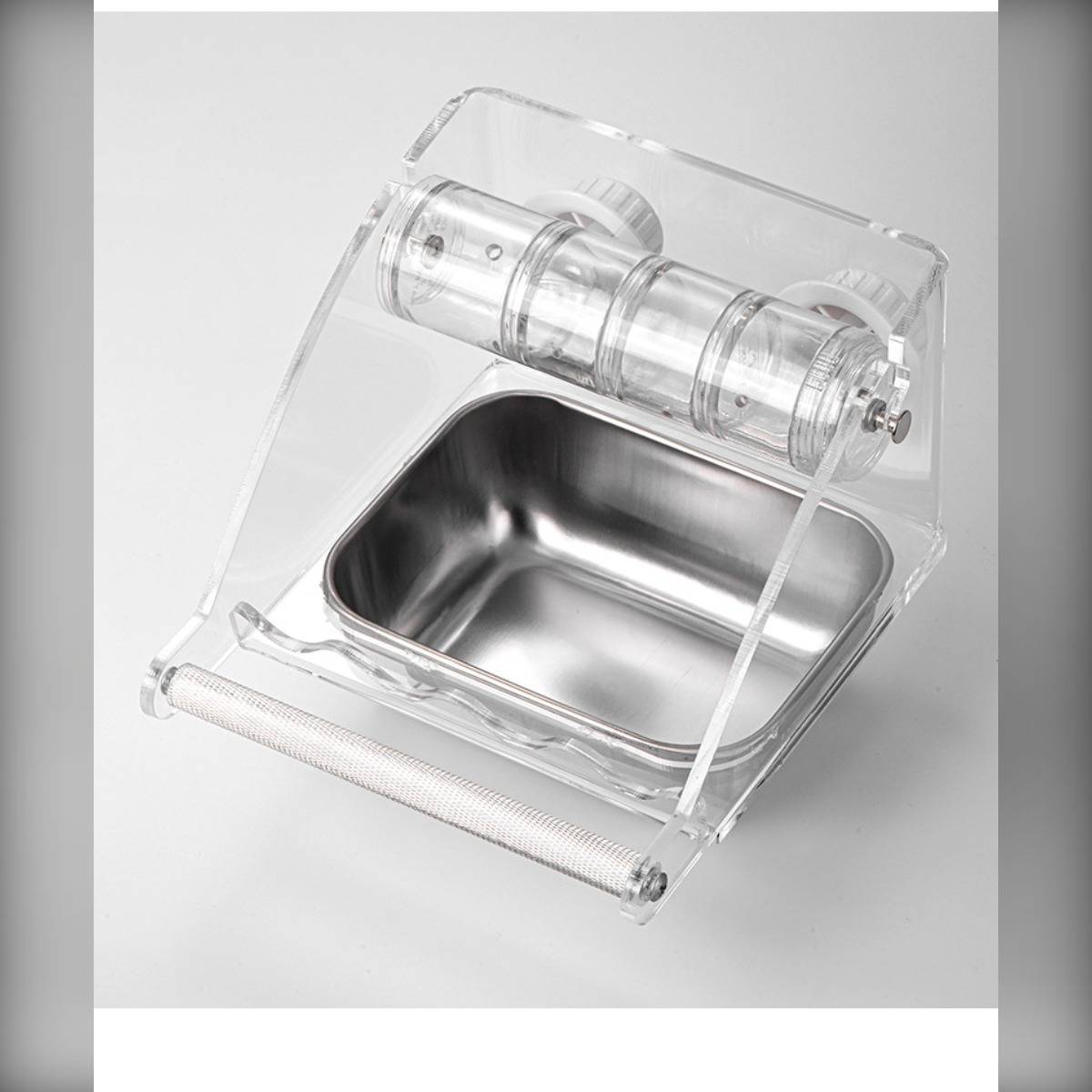 Transparenter Acryl-Tischbehälter mit Edelstahlablage und Rolldeckel, wahrscheinlich ein Lebensmittel- oder Zutatenbehälter.