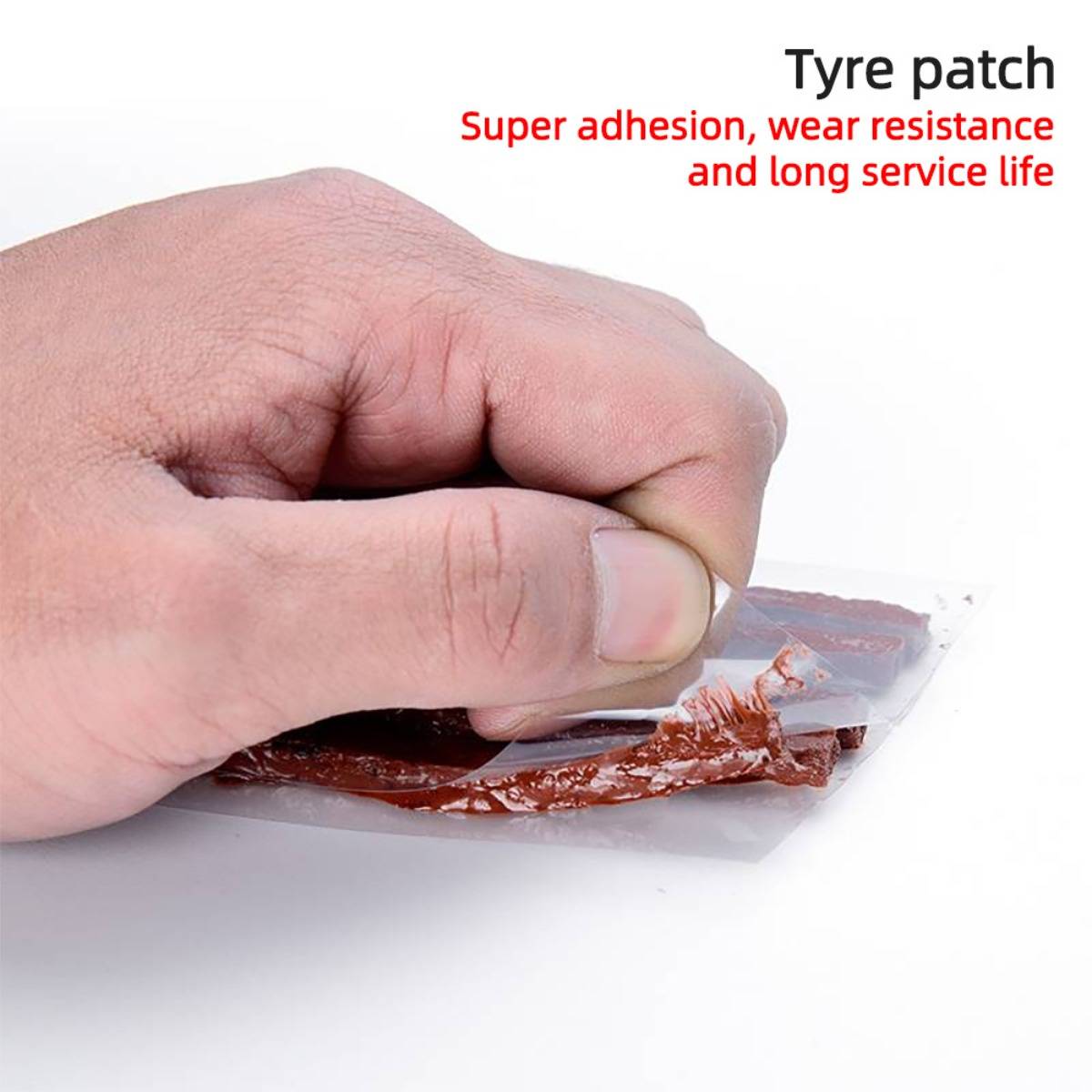 Hand entfernt einen Flicken mit der Aufschrift „Tyre patch
