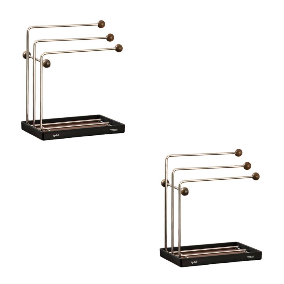 Zwei Ansichten eines minimalistischen Tischplatz-Organizers aus schwarzem Metall mit drei parallel verlaufenden Stangen und runden Holzkugel-Enden, dargestellt auf weißem Hintergrund.