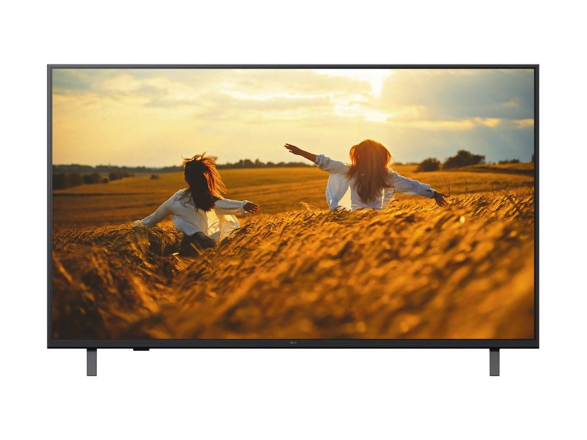 Flachbildfernseher zeigt zwei Menschen, die bei Sonnenuntergang durch ein goldenes Feld laufen