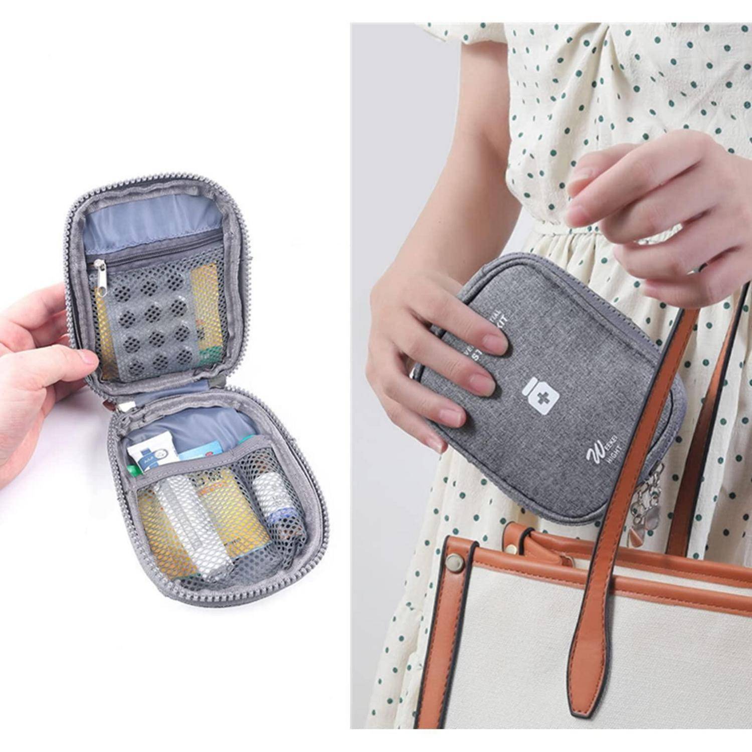 Kleine graue Erste-Hilfe-Tasche mit Reißverschluss, Netztaschen und medizinischem Zubehör, gezeigt in der Hand und an einem Handtaschenriemen befestigt für einfaches Tragen.