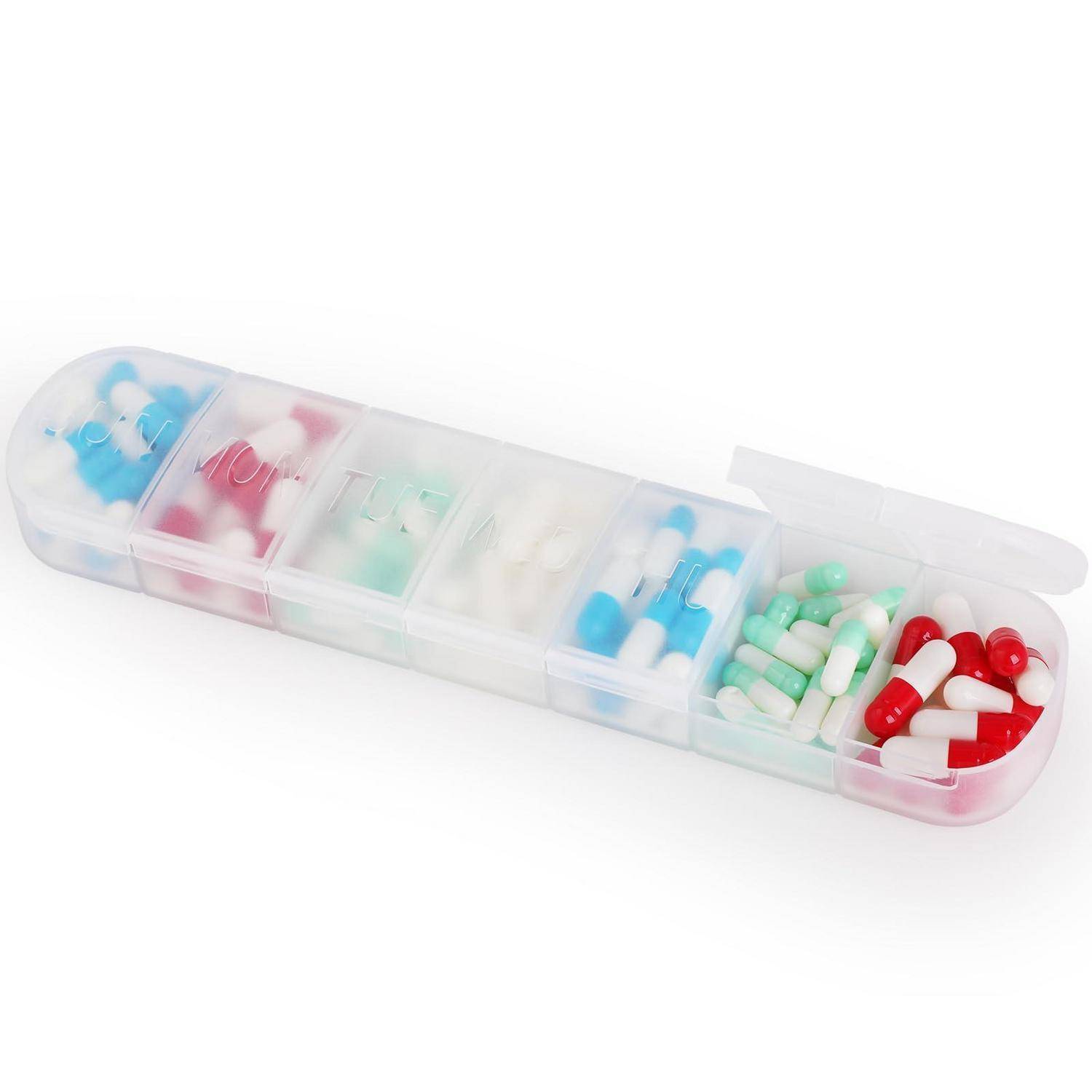 Ein transparanter Pillenbehälter mit mehreren Fächern, gefüllt mit verschiedenfarbigen Kapseln und Tabletten.