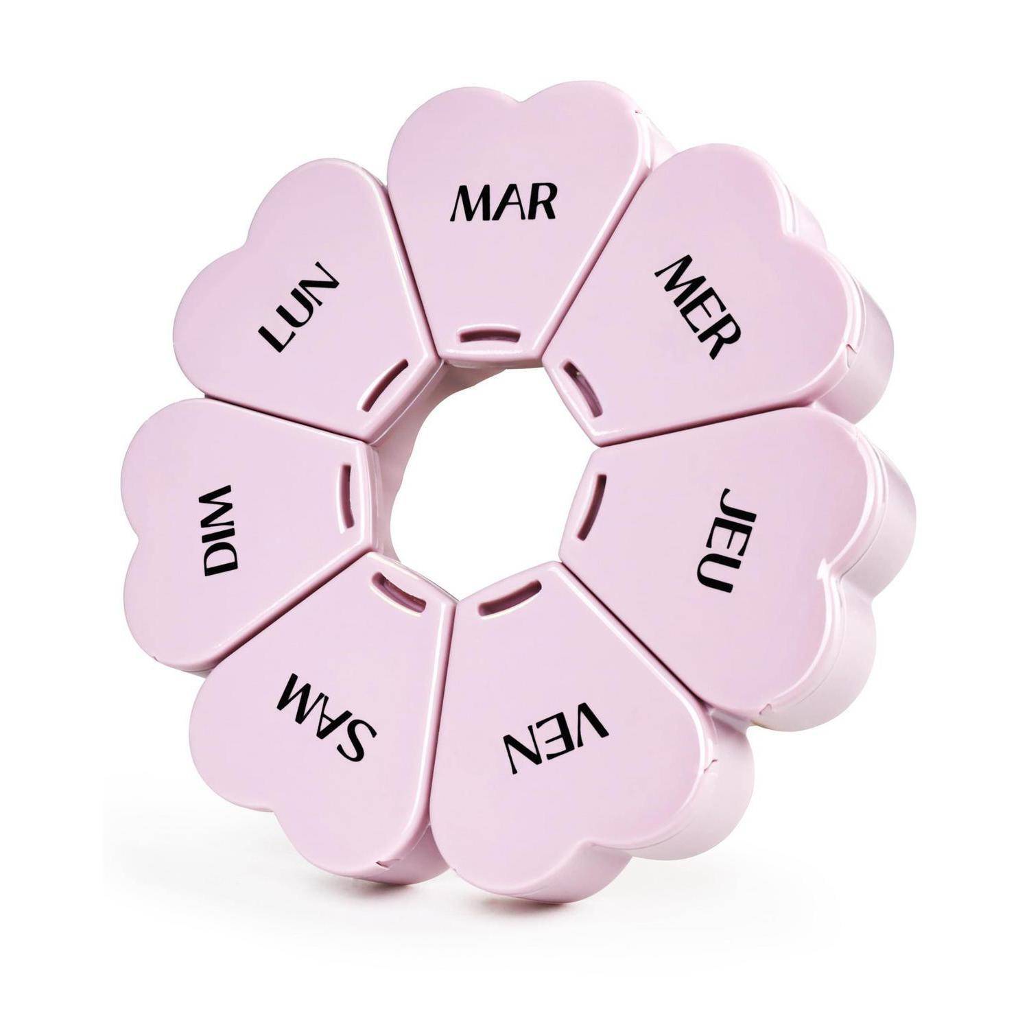 Rosa herzförmiger Pillenbehälter mit den Wochentagen in Französisch: LUN, MAR, MER, JEU, VEN, SAM, DIM.