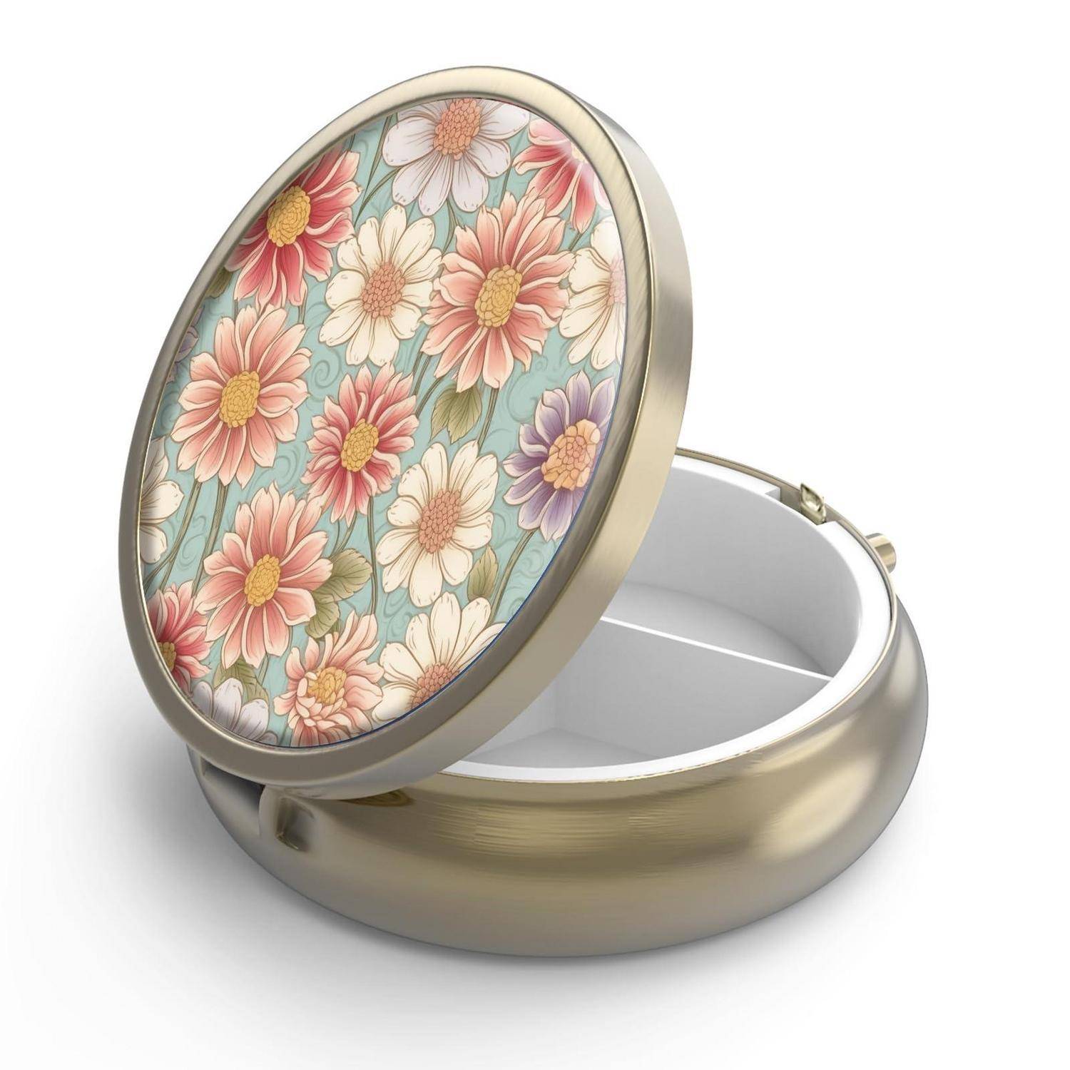 Runde Goldkästchen mit geöffnetem Deckel, verziert mit einem pastellfarbenen Blumenmuster.