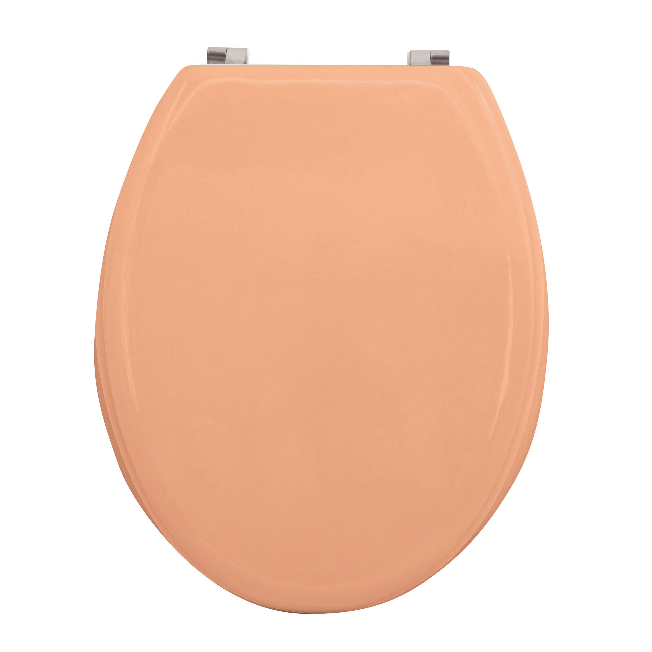 Geschlossener Toilettensitzdeckel in Pfirsichfarbe von oben auf einfachem Hintergrund betrachtet.