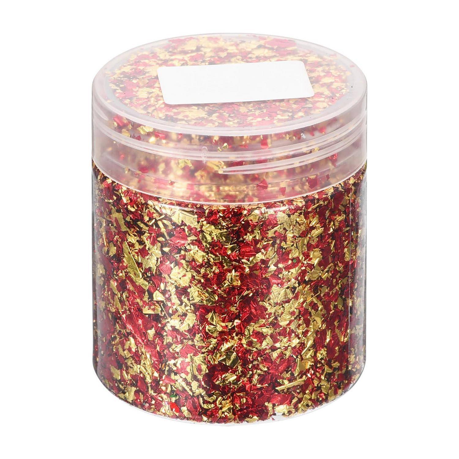 Klares Kunststoffglas gefüllt mit rot und gold glitterndem Konfetti mit einem weißen Etikett auf dem Deckel.