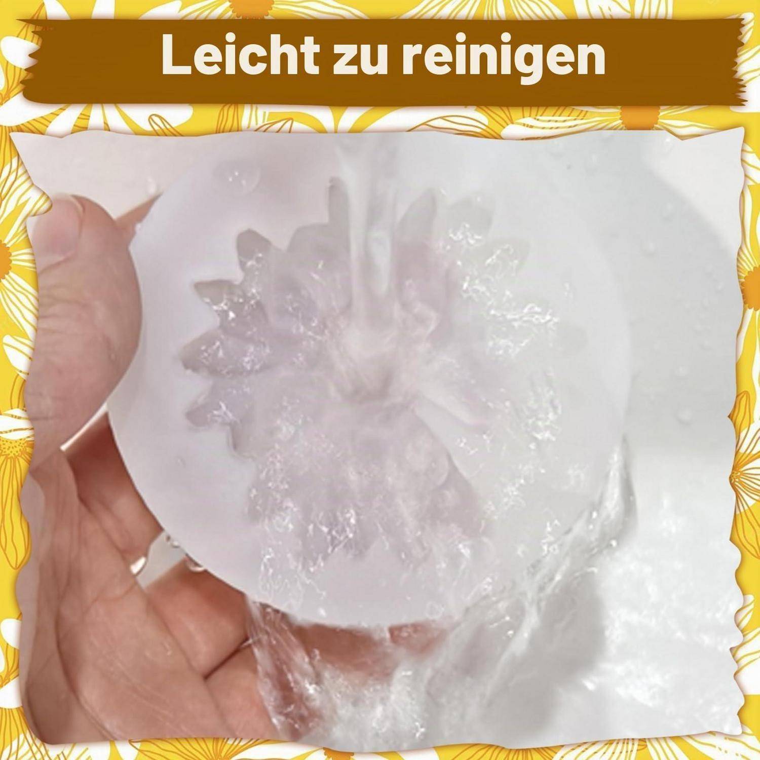Hand hält einen durchscheinenden weißen, blütenförmigen Gegenstand mit dem Text „Leicht zu reinigen