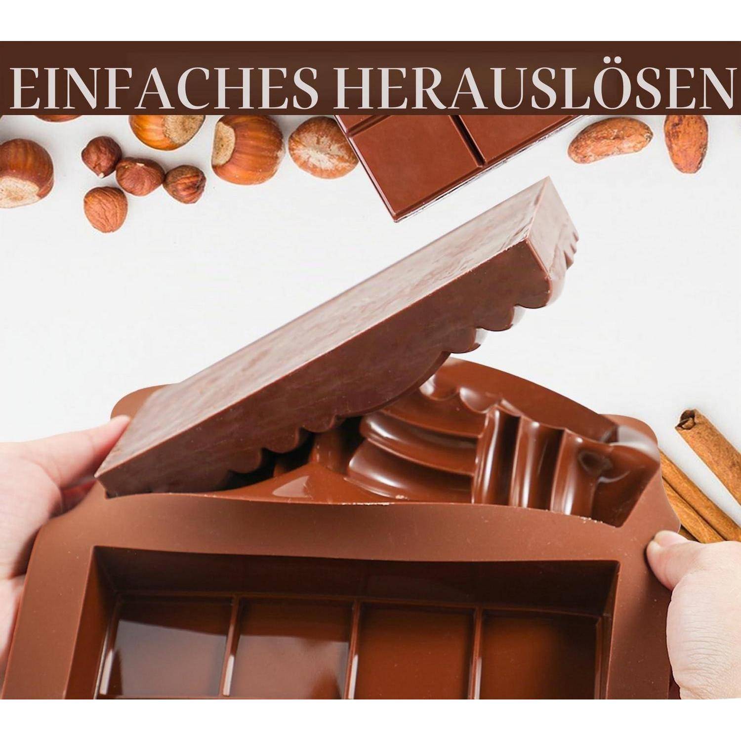 Hände öffnen eine große Schokoladenschachtel, um Schokoladen zu enthüllen, mit Haselnüssen und Zimt drum herum; der Text lautet „EINFACHES HERAUSLÖSEN