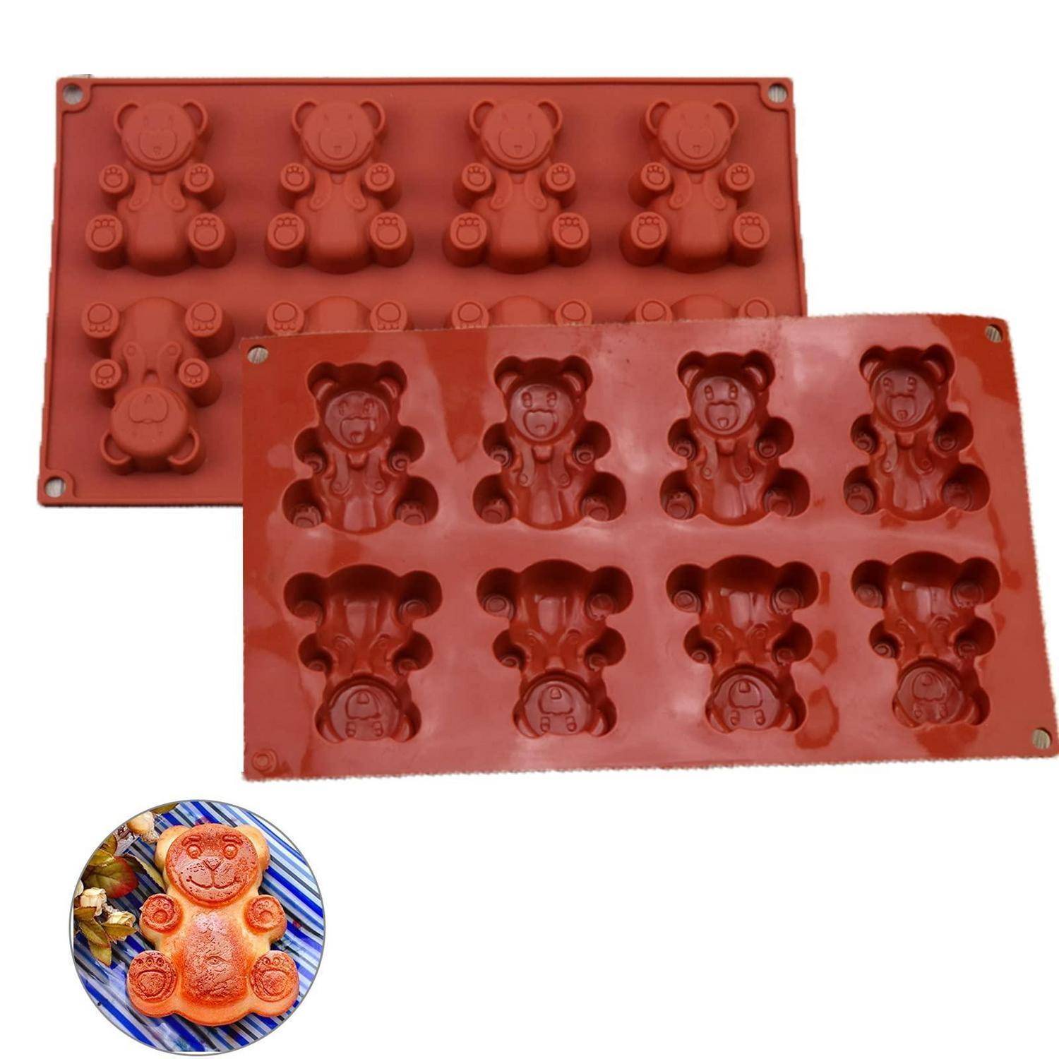 Rotes Silikonform mit Teddybär-förmigen Vertiefungen, dargestellt in zwei rechteckigen Tabletts und ein kleines Muster eines fertigen bärenförmigen Süßigkeitenartikels auf einem Teller.