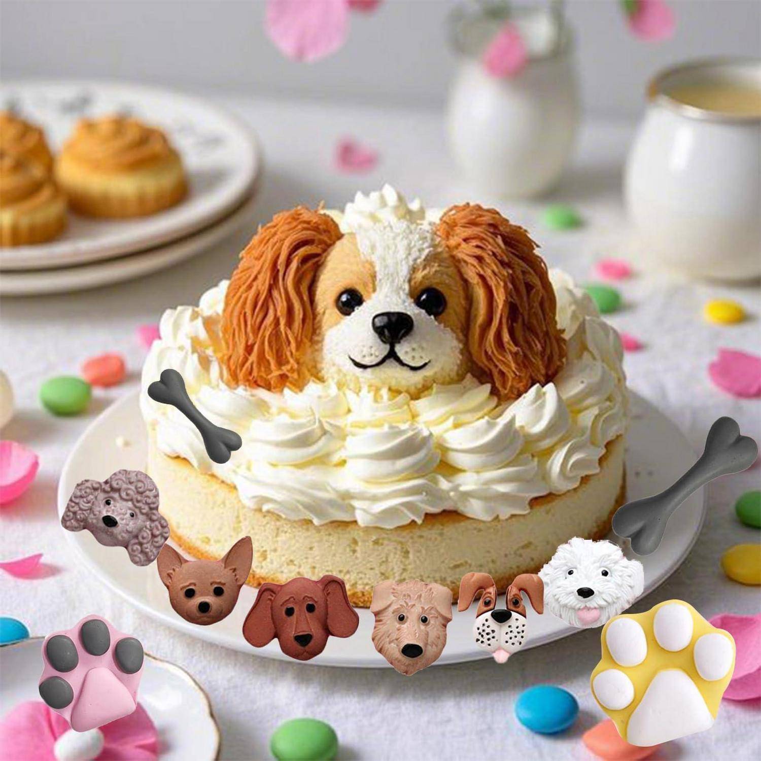 Hundeförmige Torte mit Schlagcreme, verziert wie ein Spanielgesicht und Pfotenpausen, auf einem Tisch mit bunten Süßigkeiten und Cupcakes.