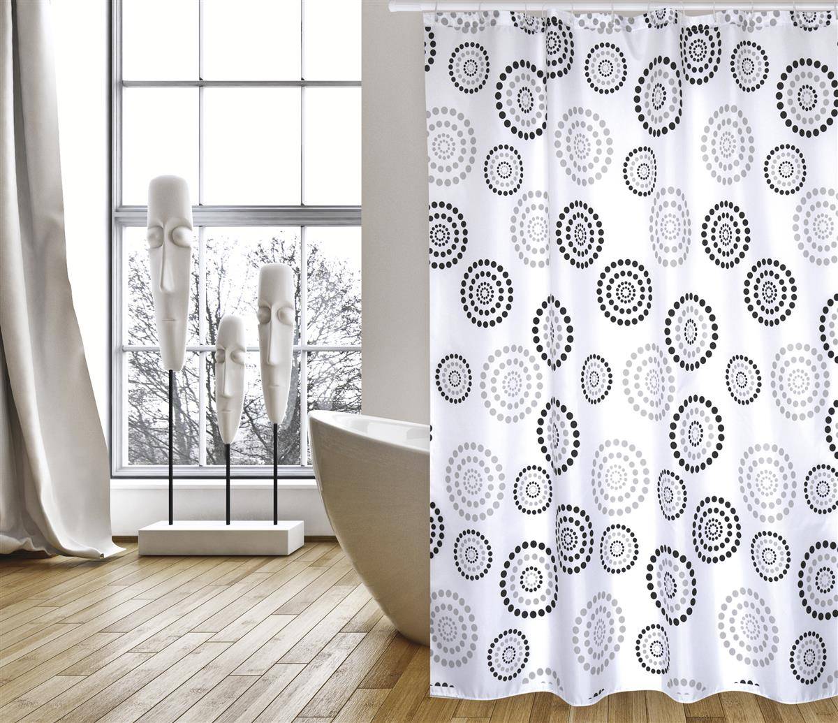 Badezimmer mit einem weißen Duschvorhang mit schwarzen und grauen Kreisen neben einem Fenster und dekorativen Skulpturen auf einem Holzboden.