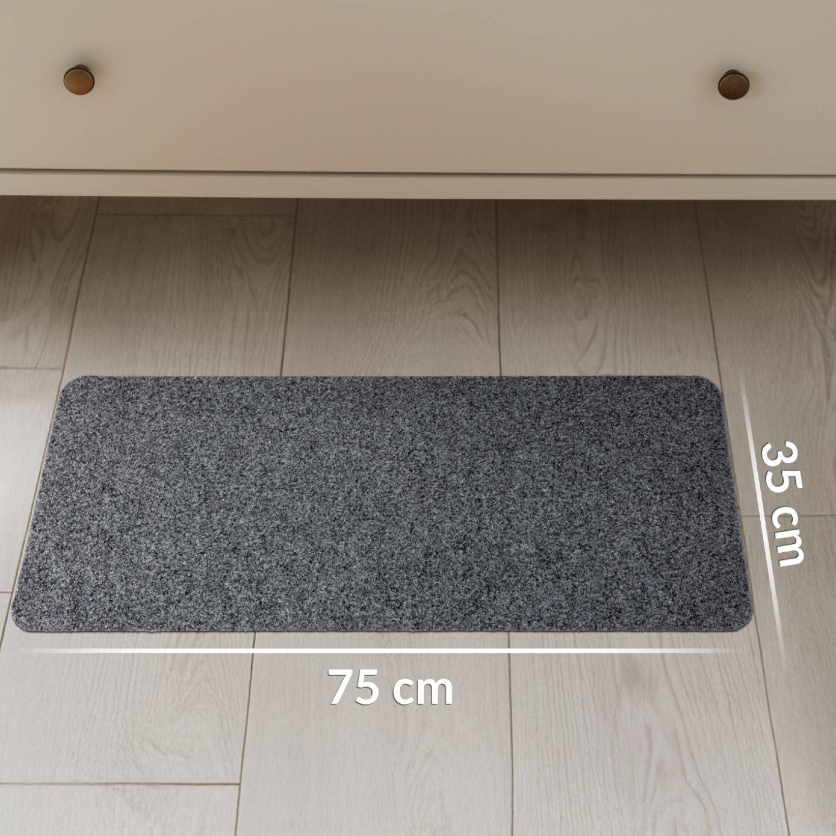 Graue rechteckige Bodenmatte auf hellem Holzfußboden, beschriftet mit 75 cm Breite und 35 cm Tiefe.