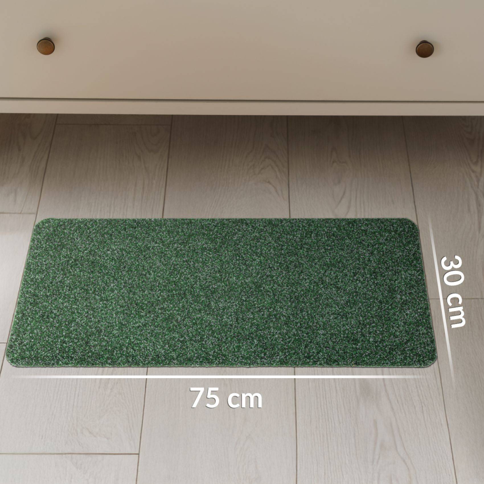 Grüne rechteckige Bodenmatte auf hellem Holzboden gezeigt, beschriftet mit 75 cm Breite und 30 cm Tiefe.