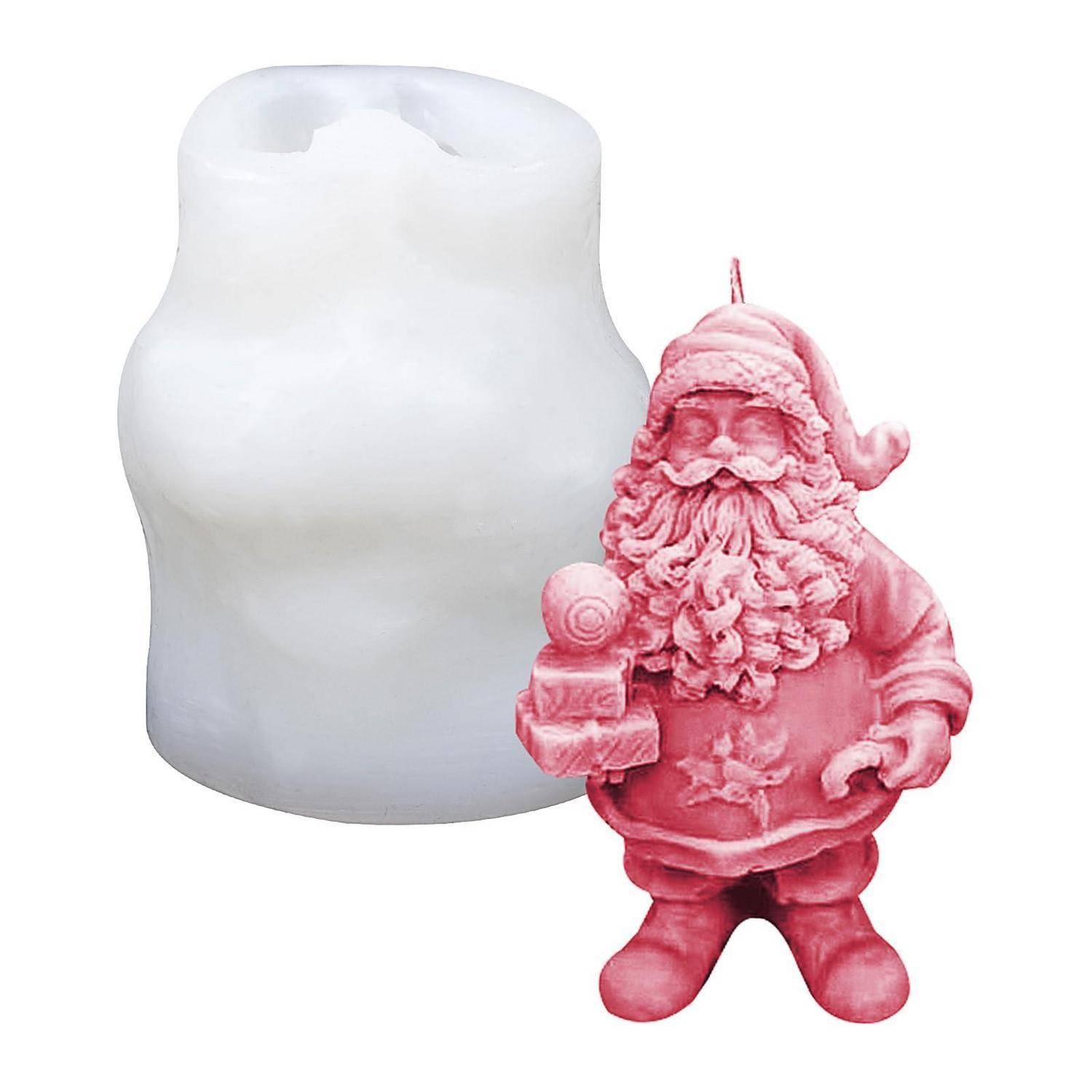 Rosa weihnachtsmännlich geformte Kerze neben ihrer weißen Silikonform auf einfachem Hintergrund.