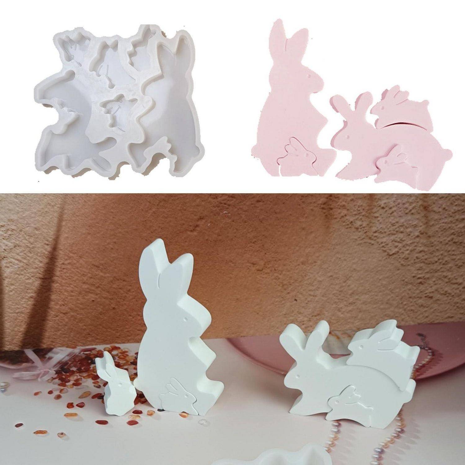 Weiße und rosa kaninchenshaped Verschachtelungspuzzleteile, die als Formen oder Ausschnitte dargestellt sind, mit zusammengesetzten Beispielen auf einer Tischplatte.