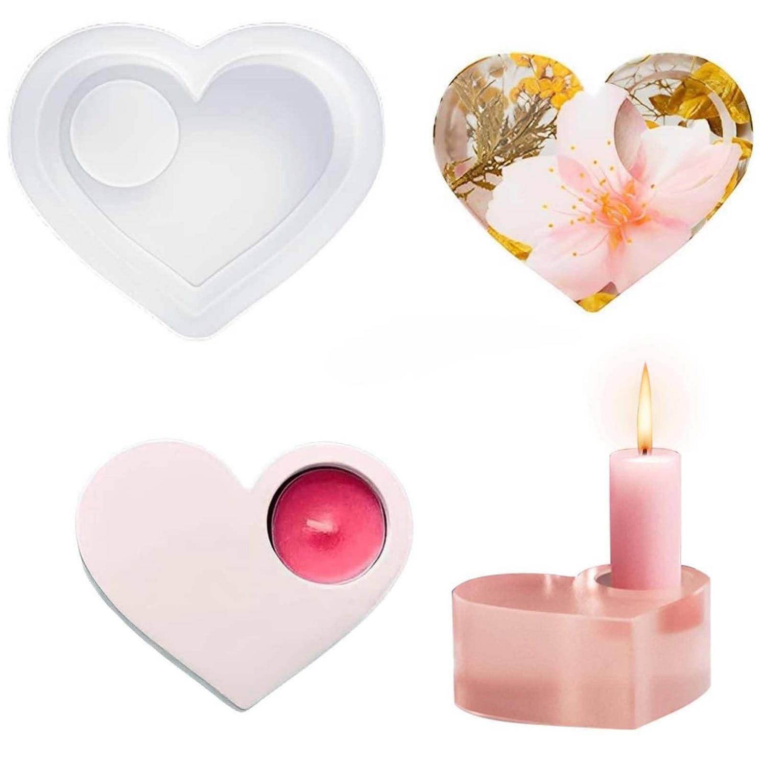 Vier herzförmige Kerzenhalter in den Stilen: schlicht weiß, florale klare Harze, rosa mit Teelicht und ein rosa Halter mit einer brennenden Kerze.