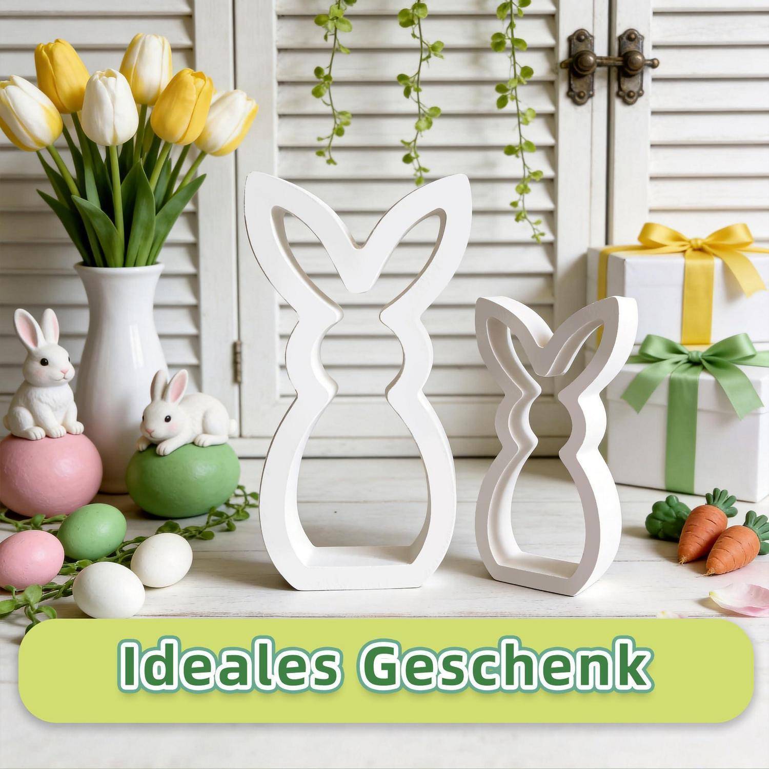 Osterliche Geschenkausstellung mit weißen hasenförmigen Holzausschnitten, Tulpen, verzierten Eiern, Hasenfiguren und Geschenkboxen; Beschriftung lautet „Ideales Geschenk