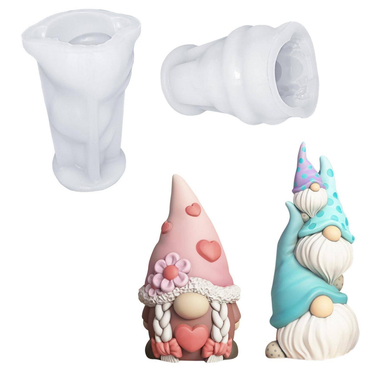 Assortierte silikon gnomförmige Formen und fertige Gnomfiguren, einschließlich einfacher weißer Formteile und dekorierter Pastellzwerge mit Herzen und Blumen.