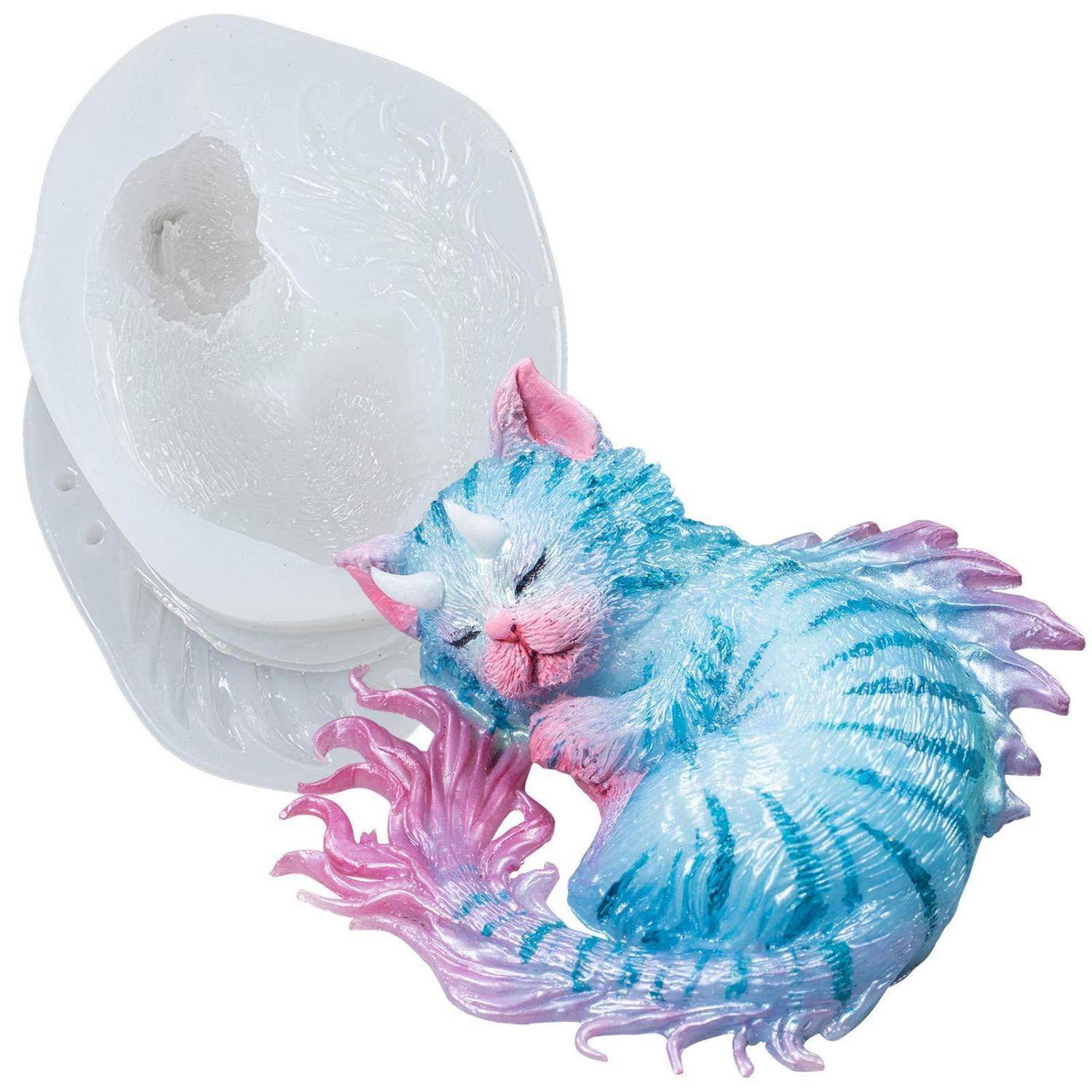 Blau-rosa Schlafkatzen-Figur neben einer durchsichtigen runden Form oder Verzierungsform.