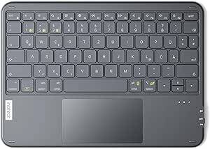 Draufsicht auf eine kompakte dunkelgraue Laptop-Tastatur und ein großes Touchpad, wahrscheinlich ein Chromebook, mit sichtbarem britischem QWERTY-Layout und Zahlentasten.